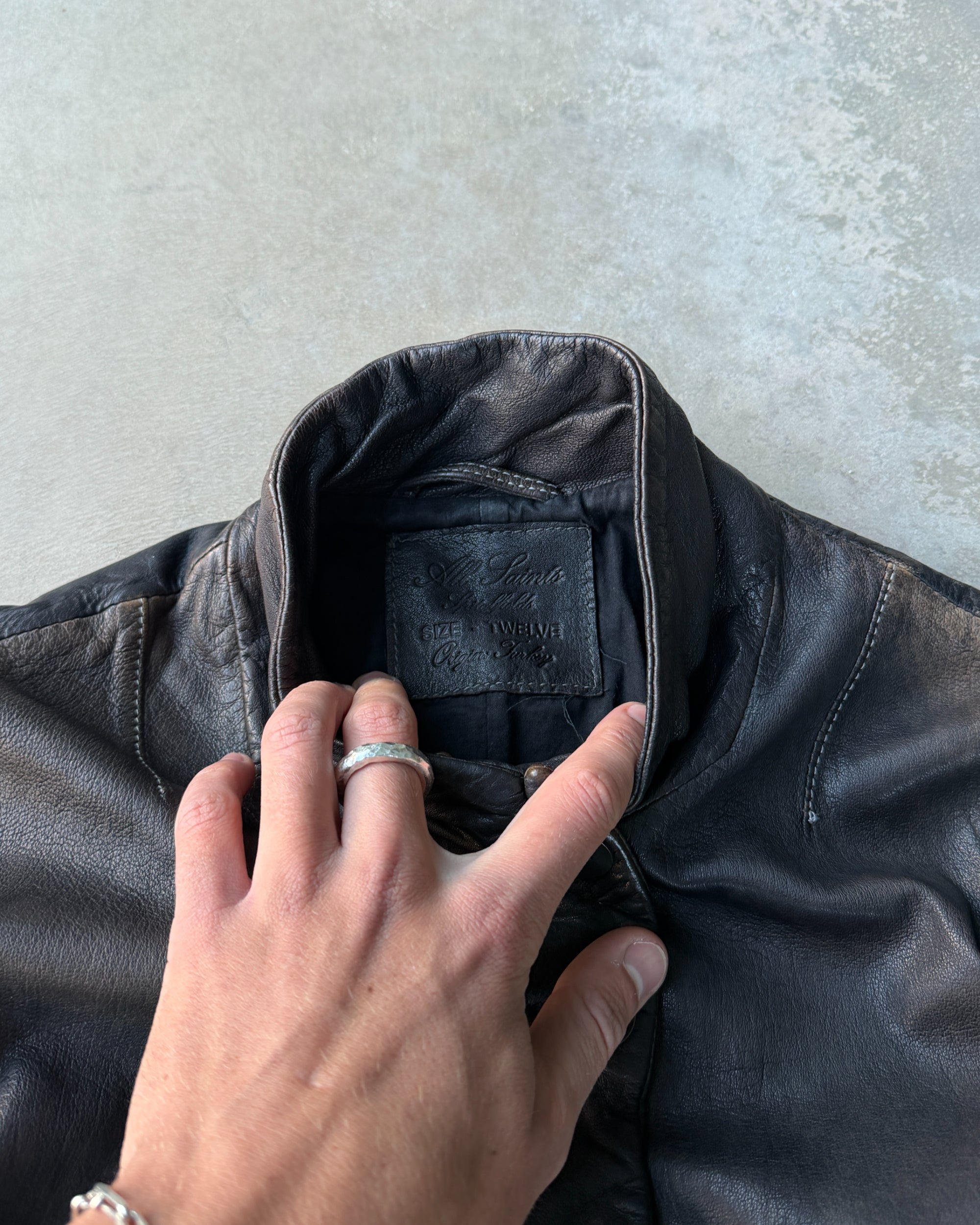 AllSaints 1990s Button-Up Leather Jacket – M-on a concrete background