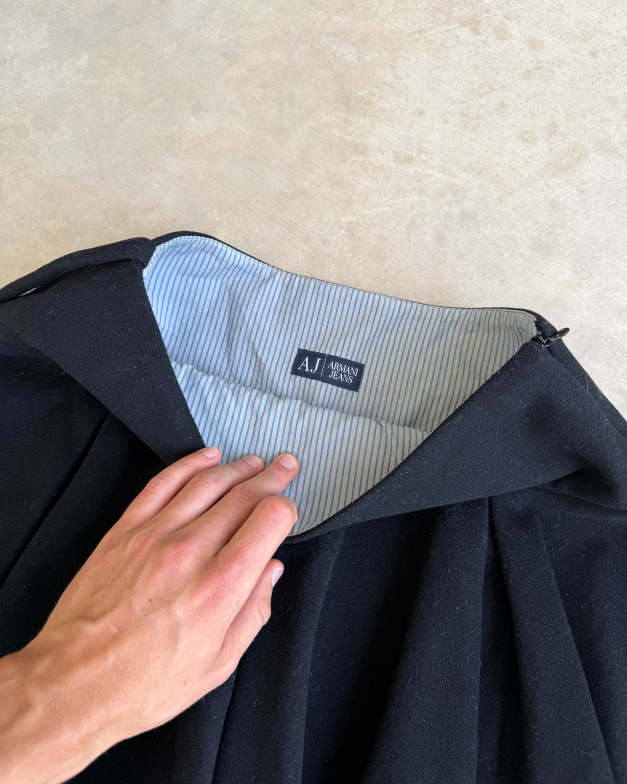 Armani Jeans Pleated Black Mini Skirt – S-on a concrete background