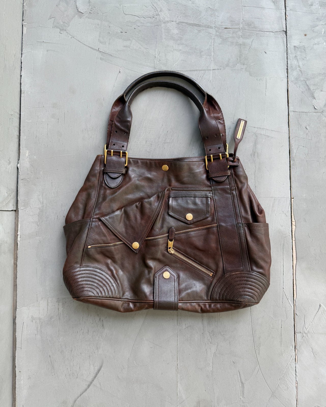 Alexander McQueen Faithful Multipocket Leather Shoulder Bag-on a concrete background