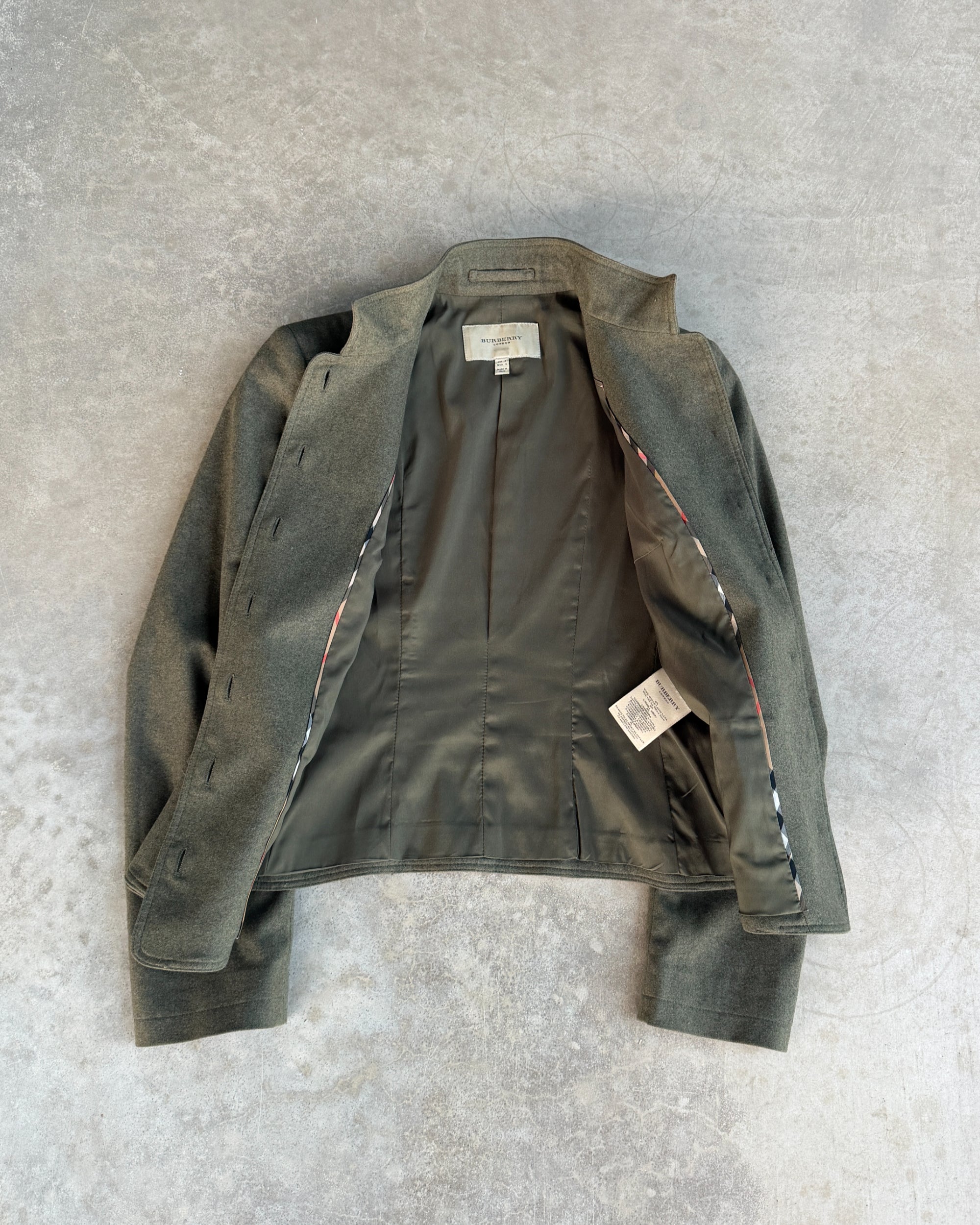 Burberry Wool and Cashmere Military Jacket – S-on a concrete background