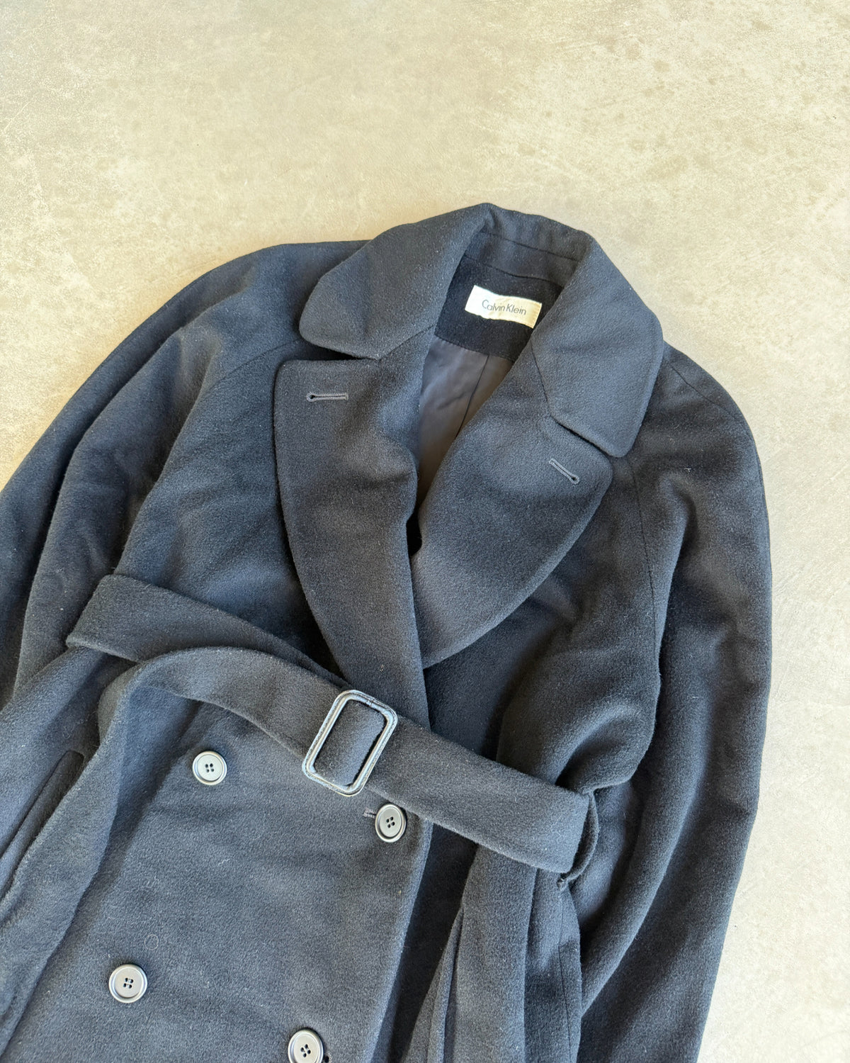 Calvin Klein Wool Trench Coat – L-on a concrete background