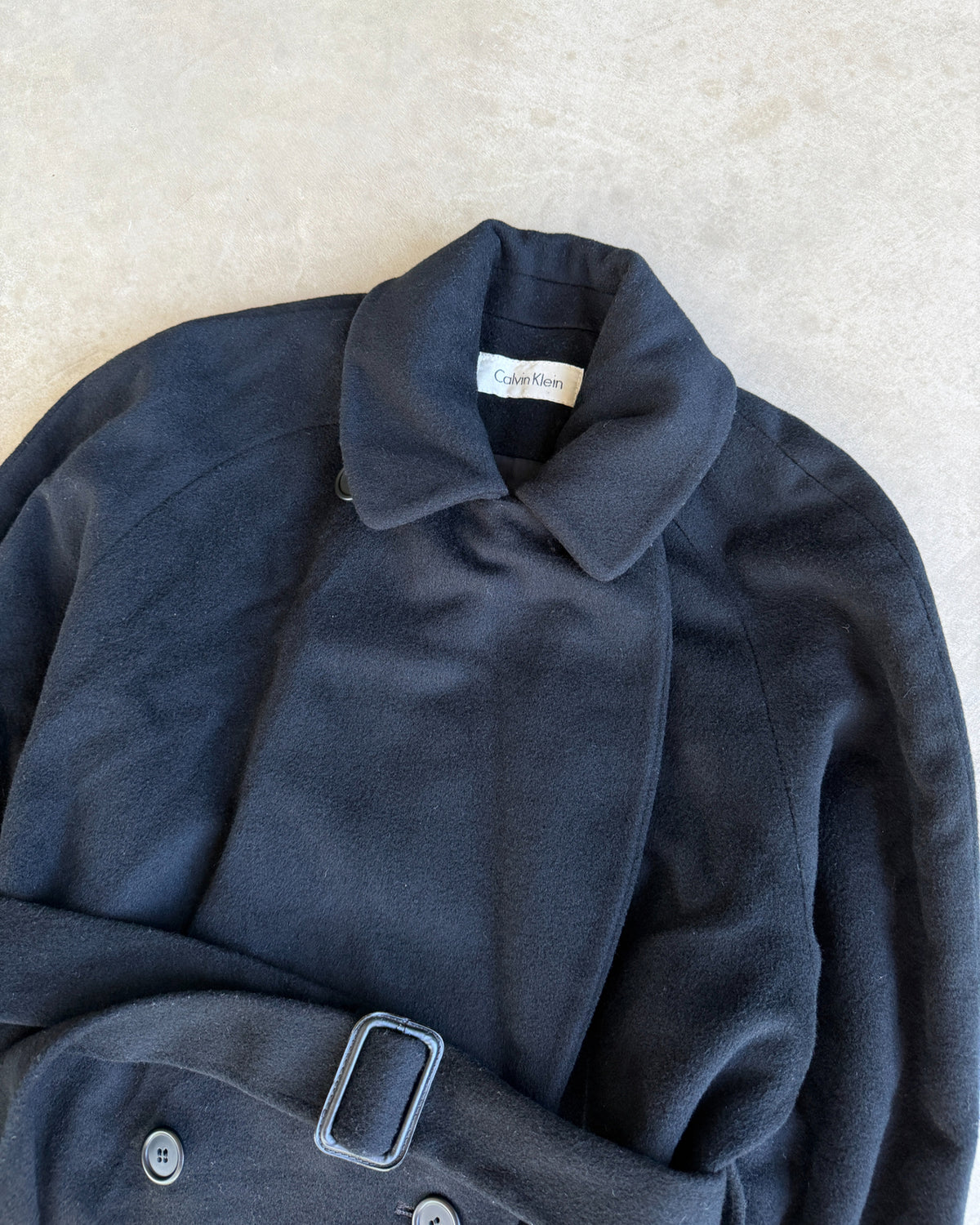 Calvin Klein Wool Trench Coat – L-on a concrete background