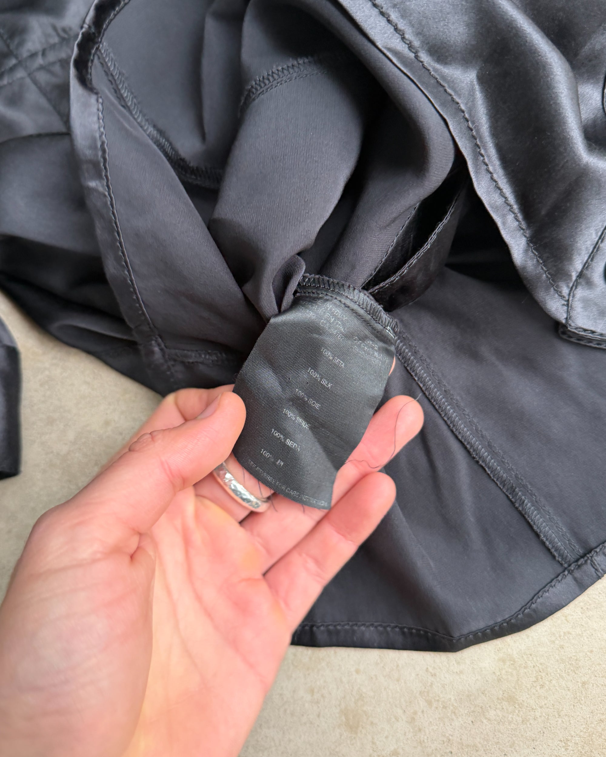 Prada Silk Asymmetric Button-Up Shirt – S-on a concrete background