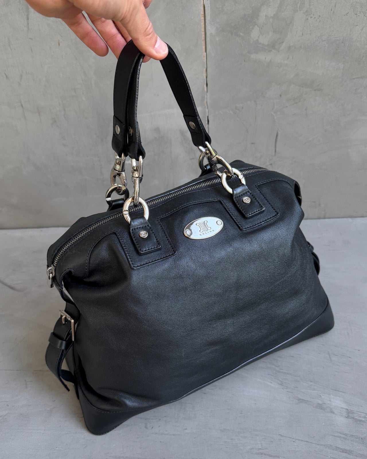 Celine Black Leather Handbag-on a concrete background