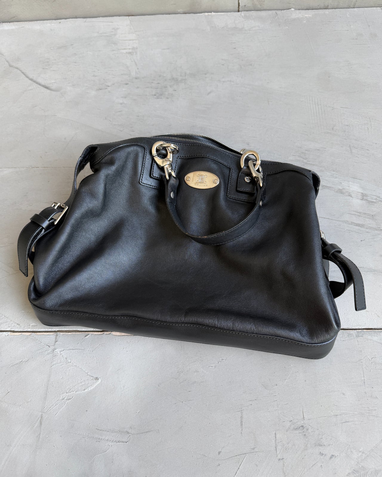 Celine Black Leather Handbag-on a concrete background