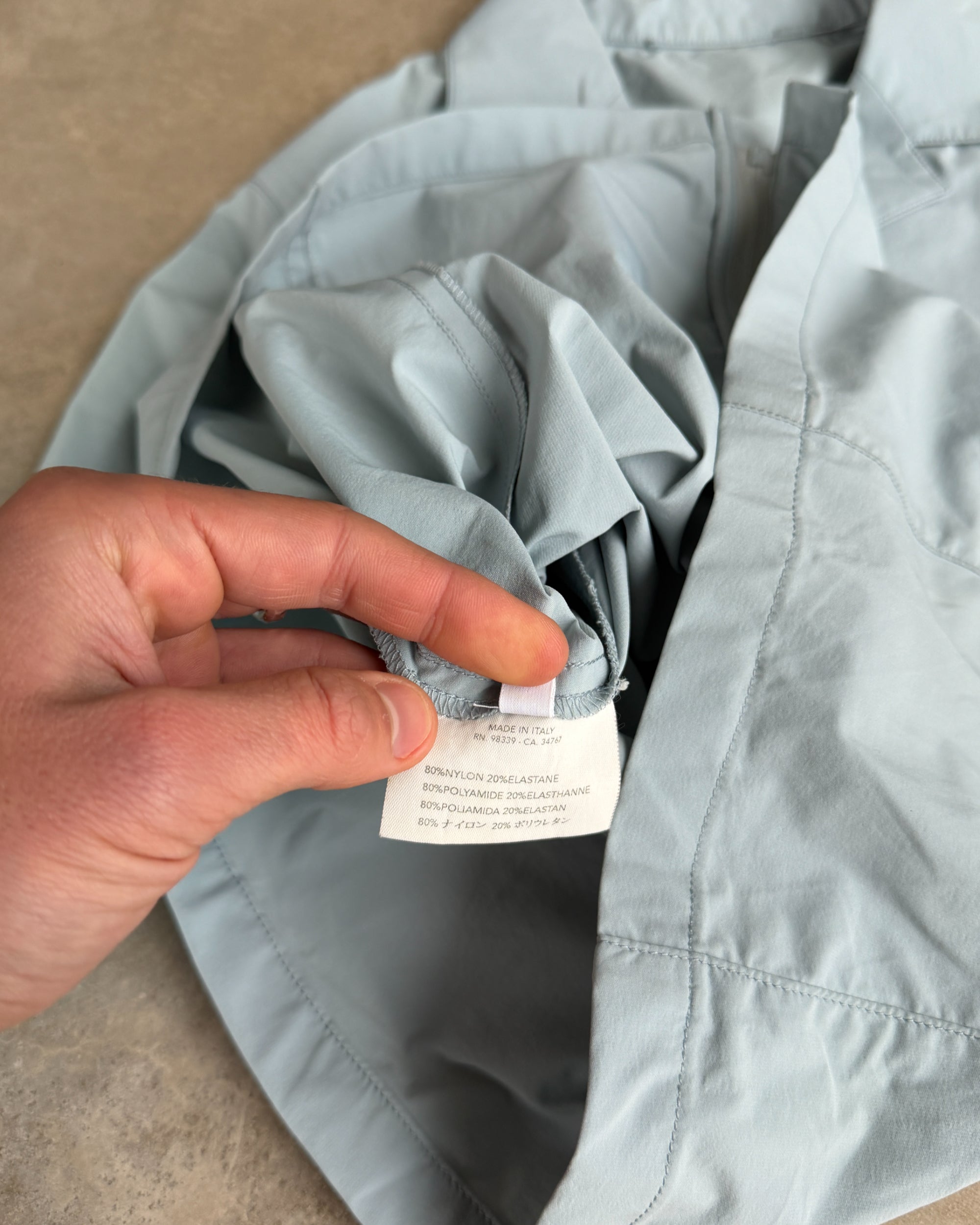 Prada SS99 Belted Nylon Short Sleeve Shirt – S-on a concrete background