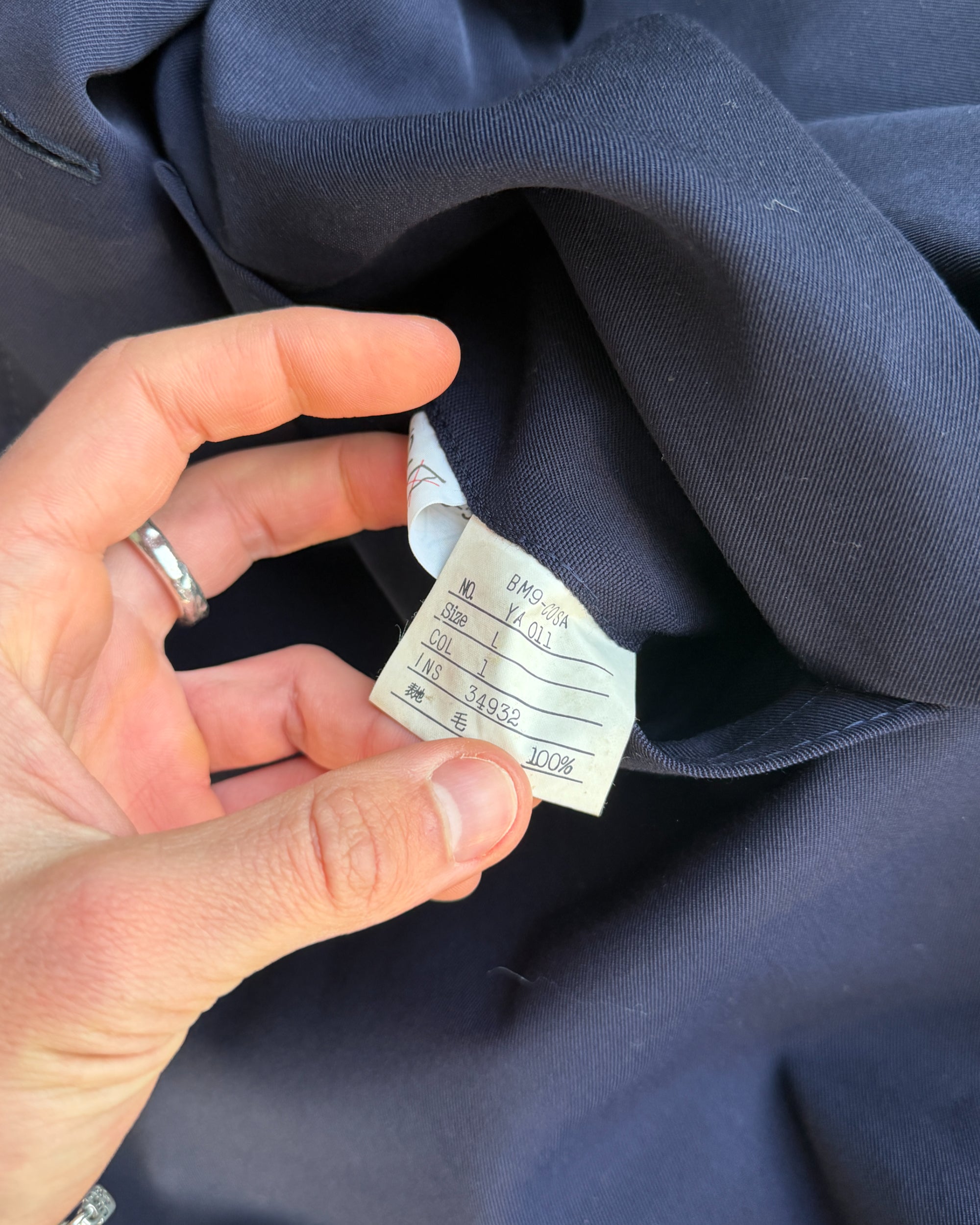 Yves Saint Laurent Wool Double Breasted Mac Coat – M-on a concrete background