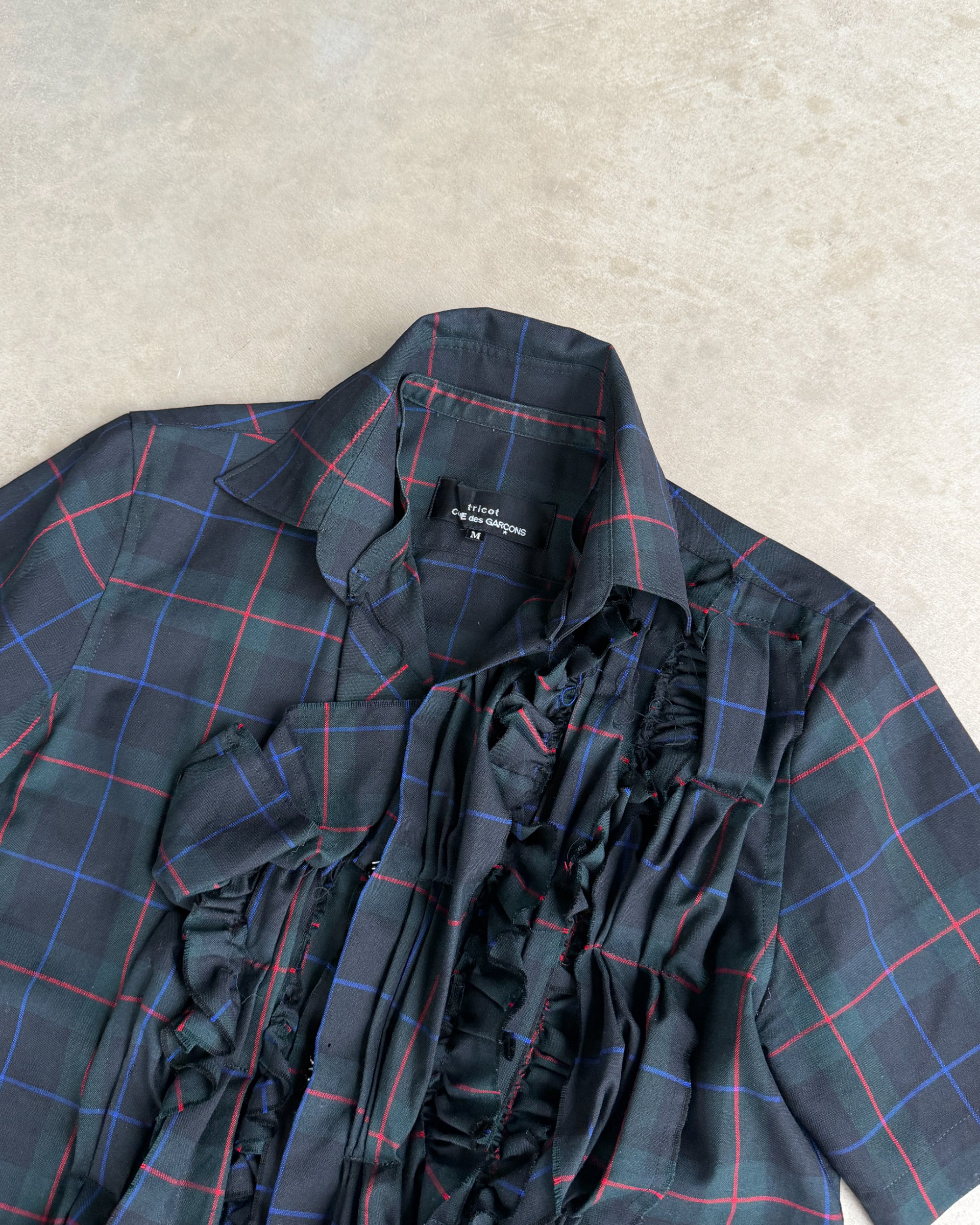 Comme des Garçons Tricot AW04 Checkered Short Sleeve Shirt – M-on a concrete background