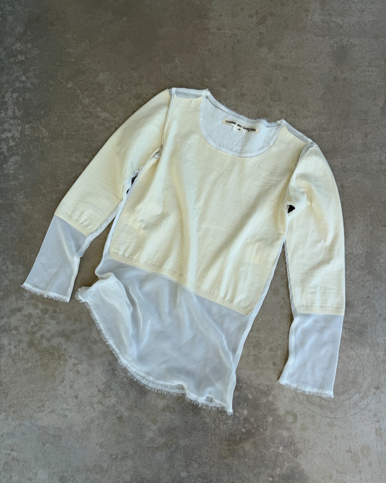 Comme des Garçons AW2012 Wool and Mesh Long Sleeve T-Shirt – M-on a concrete background
