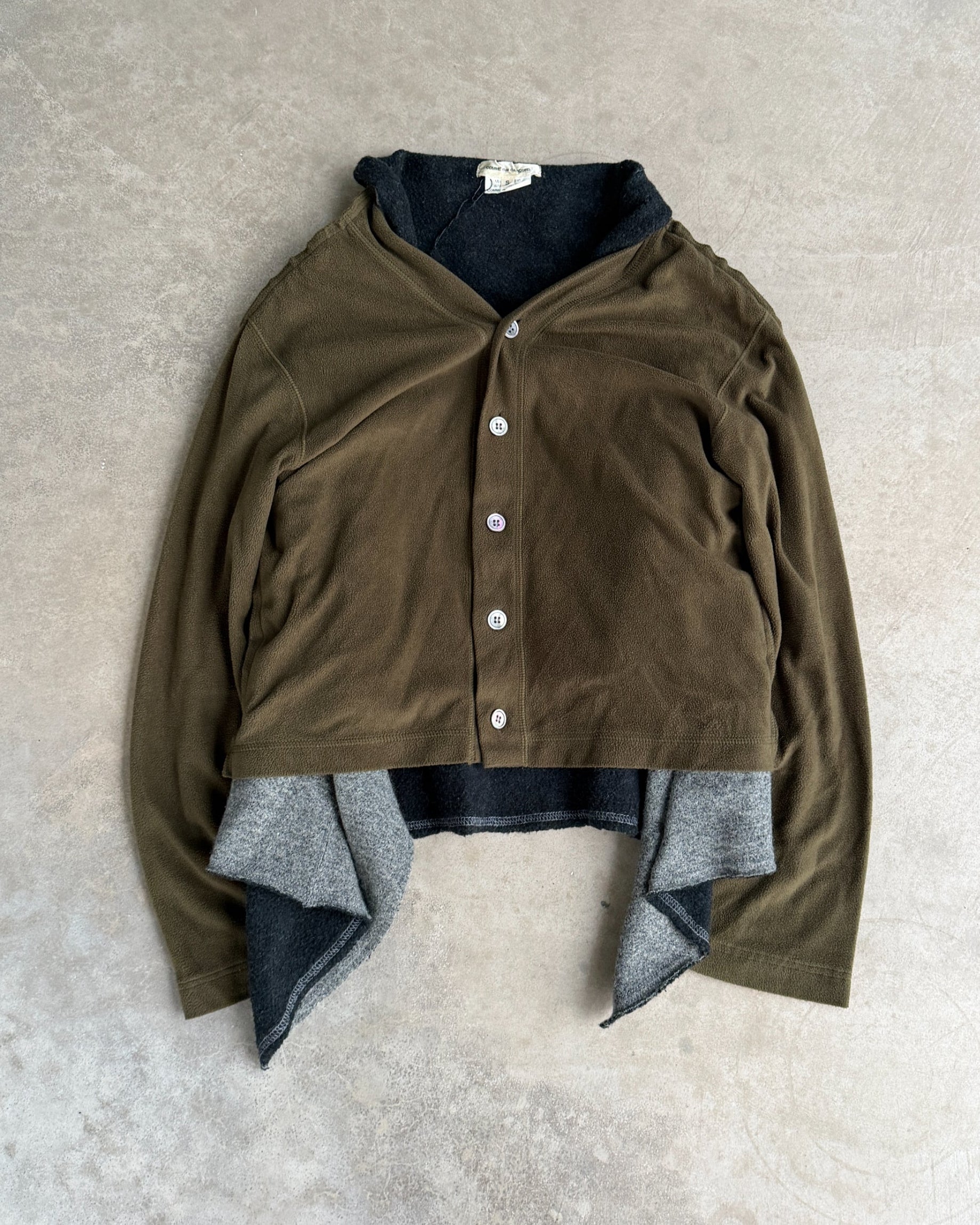 Comme des Garçons 2009 Layered Armhole Cardigan – XS–S-on a concrete background