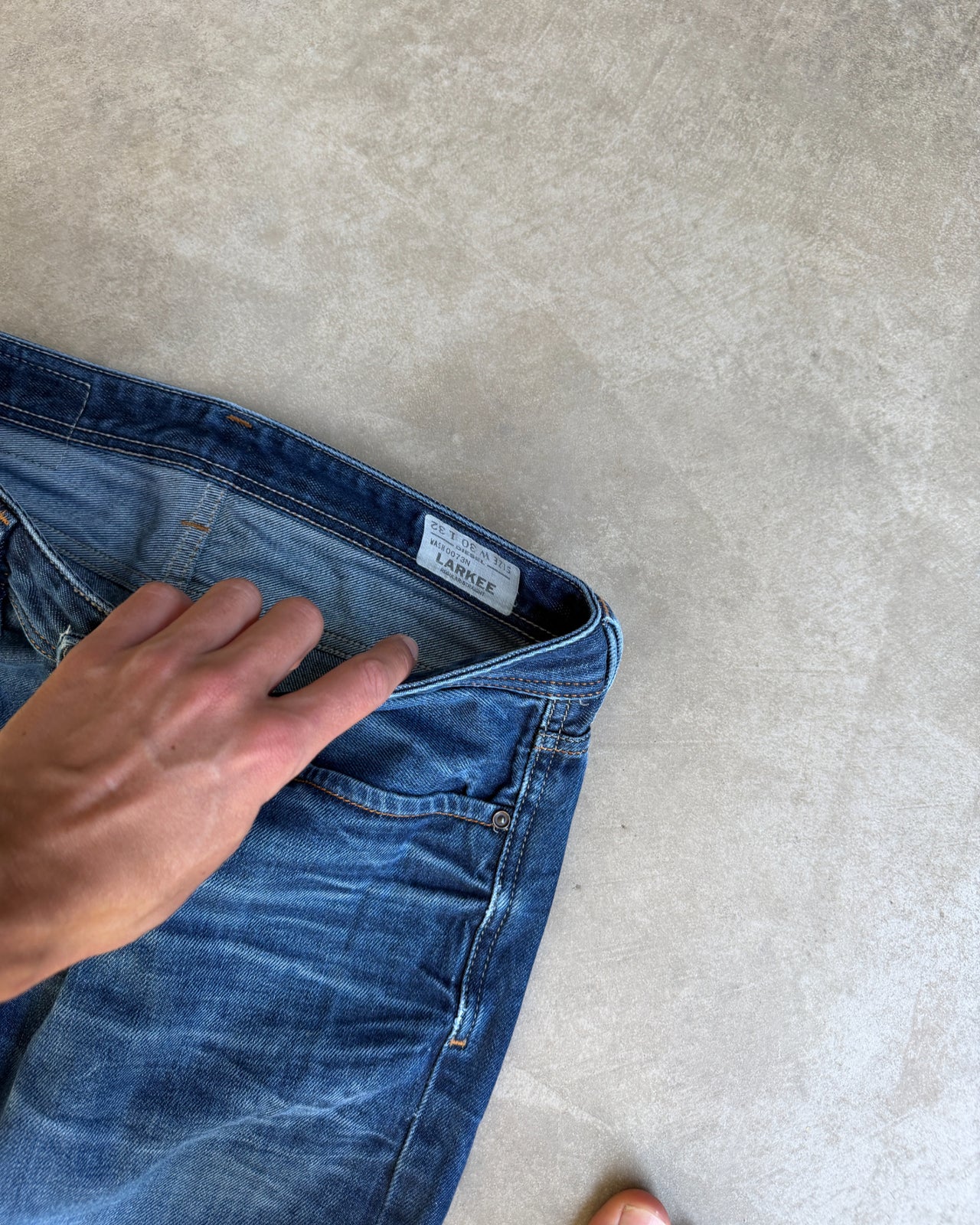 Diesel Mid Blue Distressed Straight Leg Jeans – W30/L28-on a concrete background