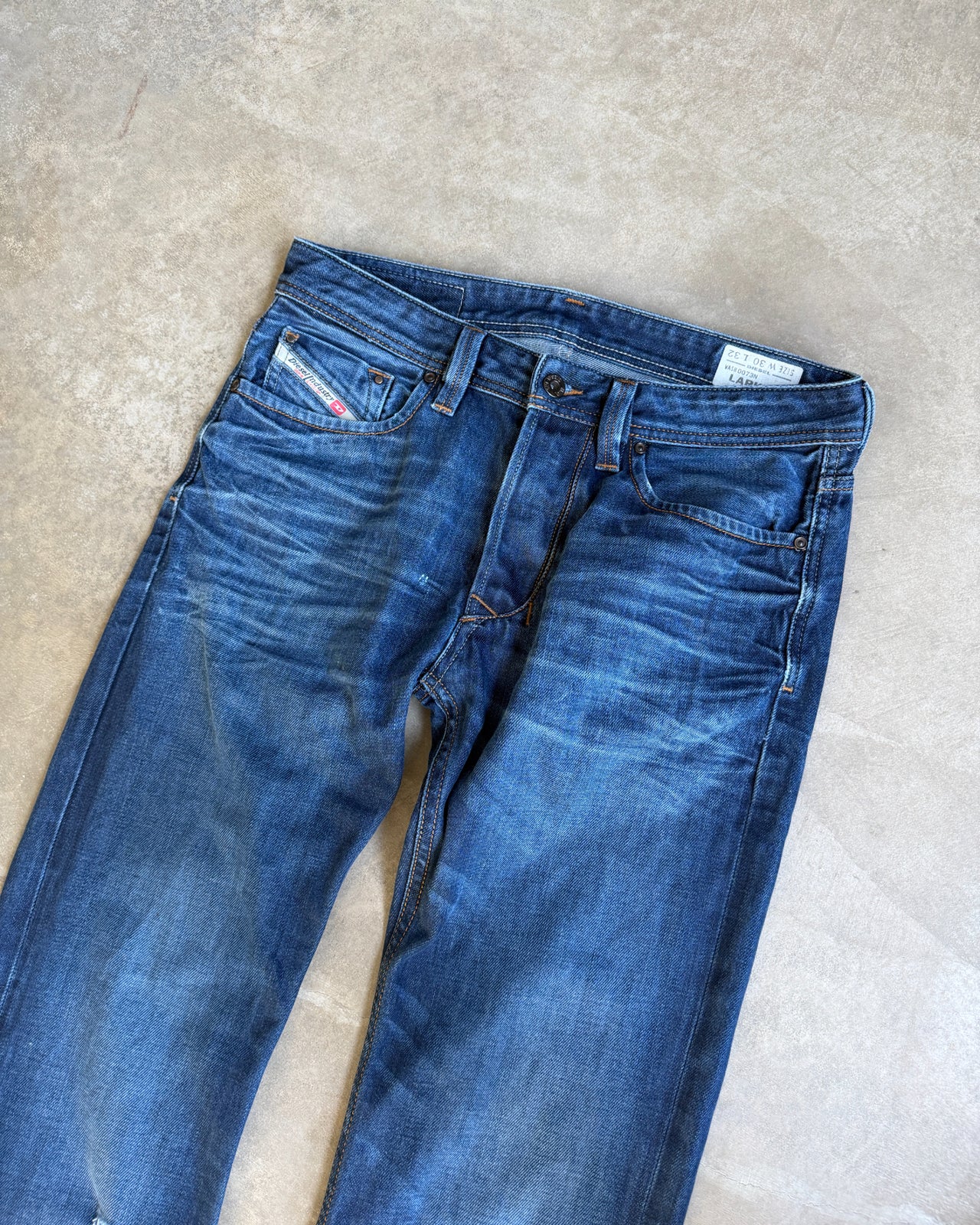 Diesel Mid Blue Distressed Straight Leg Jeans – W30/L28-on a concrete background