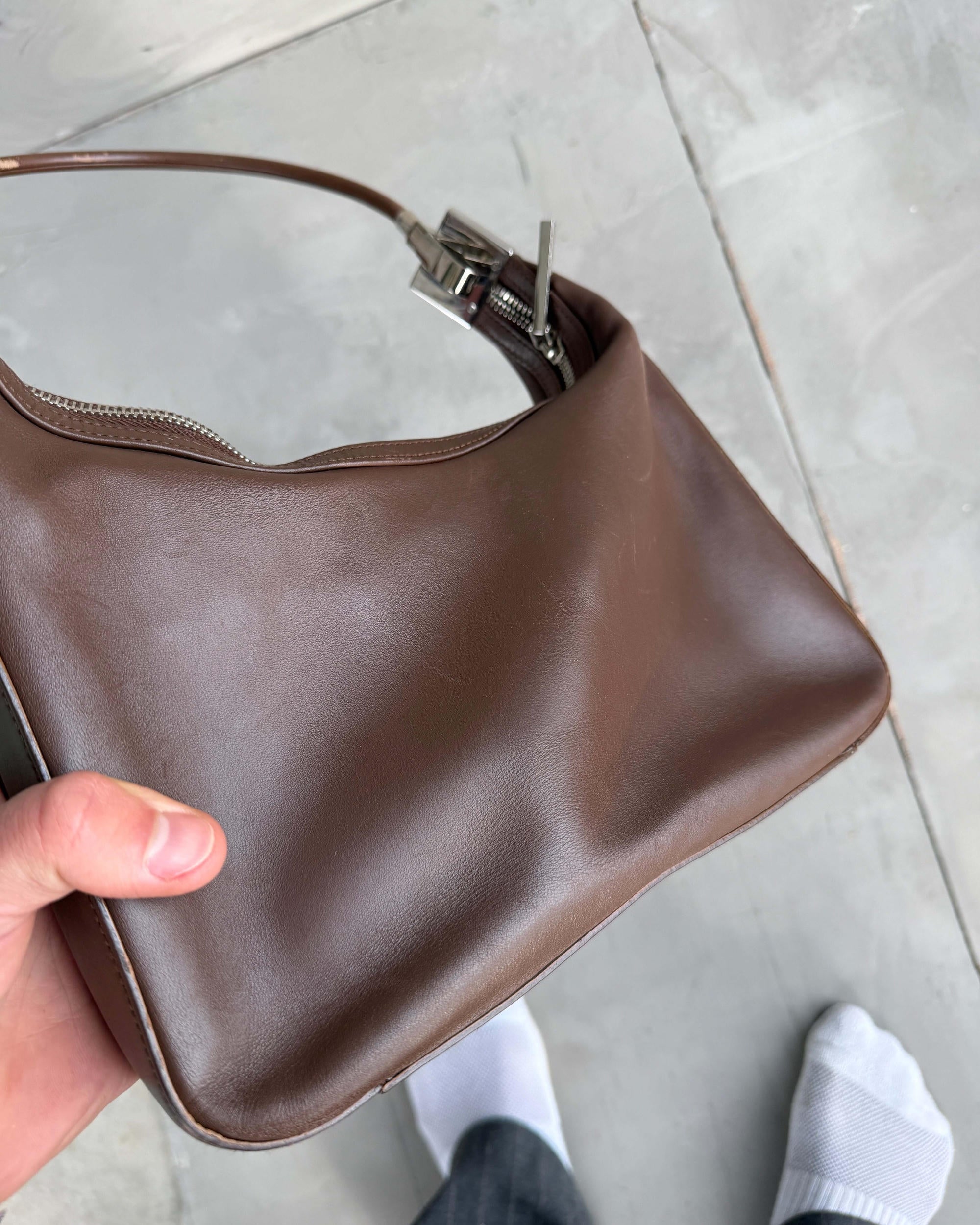 Gucci Asymmetric Structured Leather Shoulder Bag-on a concrete background