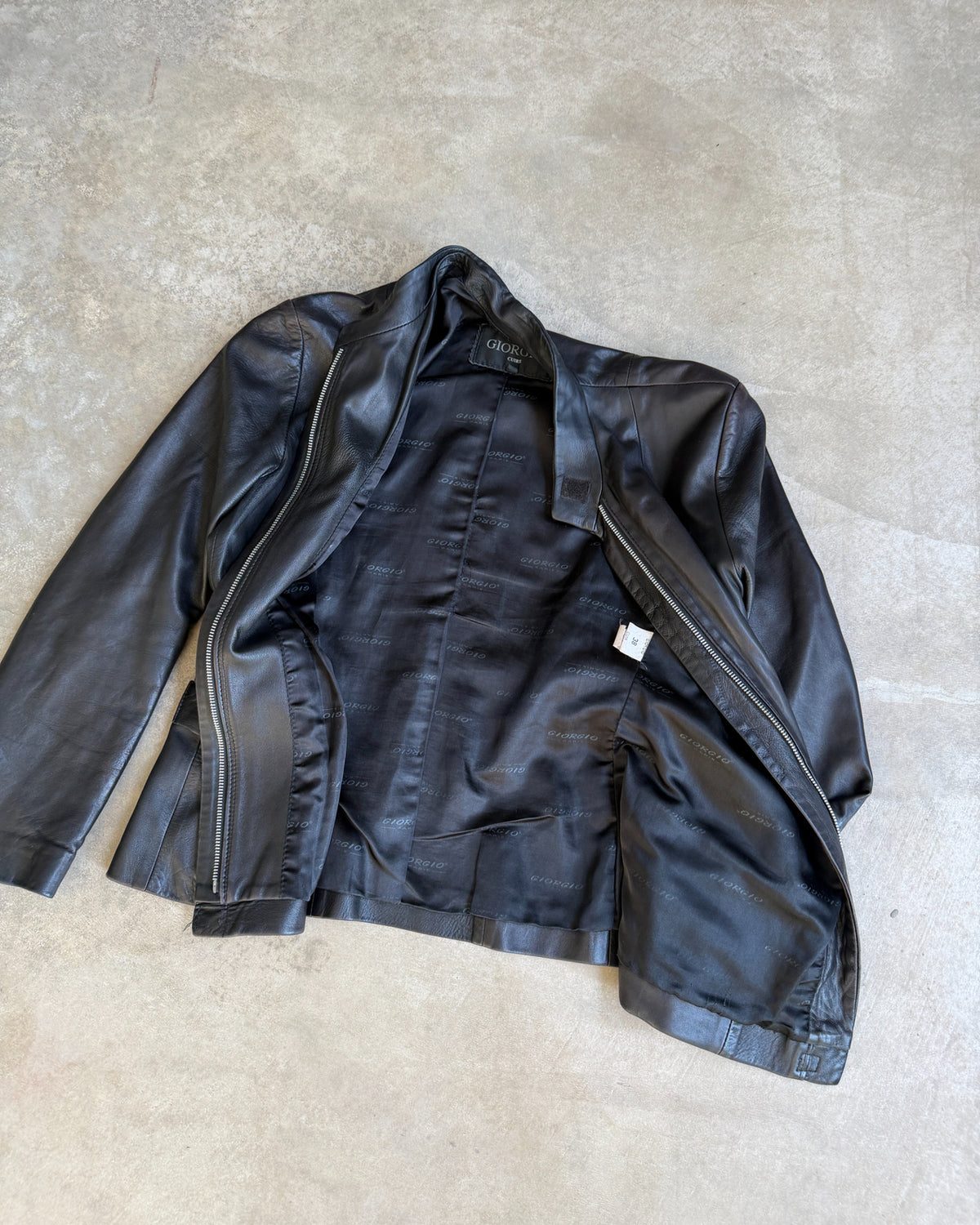 Giorgio Black Leather Jacket – XS/S-on a concrete background
