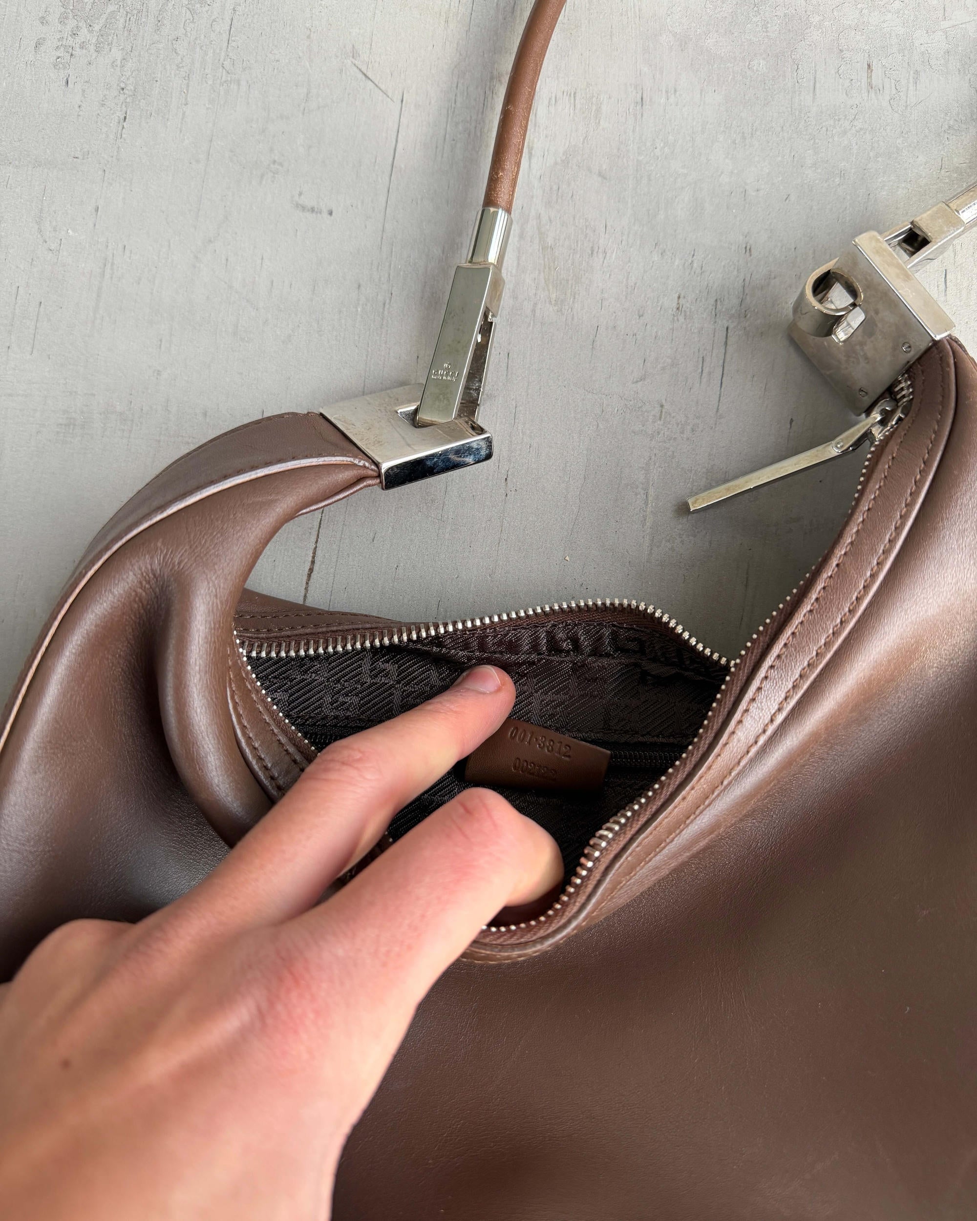 Gucci Asymmetric Structured Leather Shoulder Bag-on a concrete background