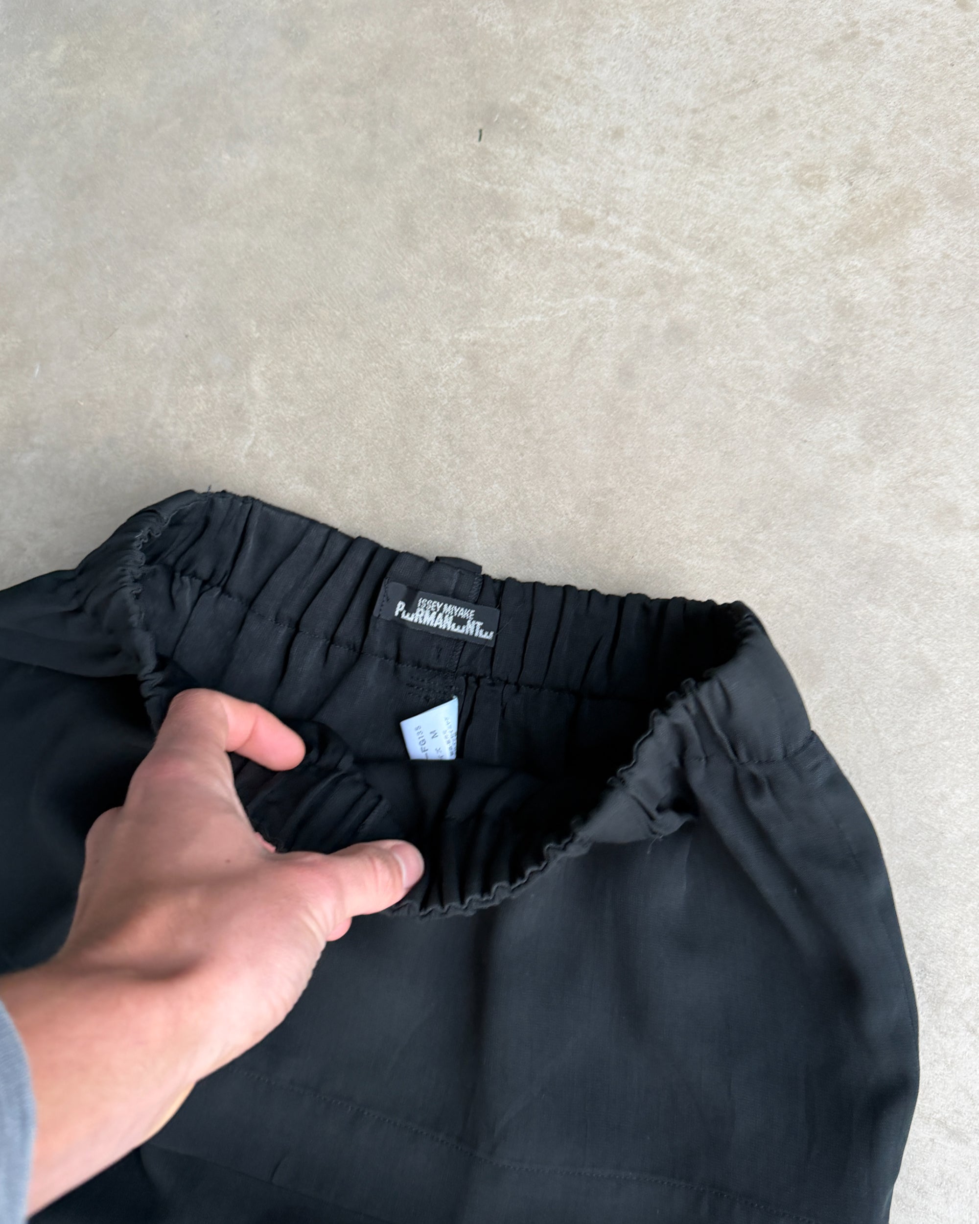 Issey Miyake Permanente Maxi Skirt – S-on a concrete background