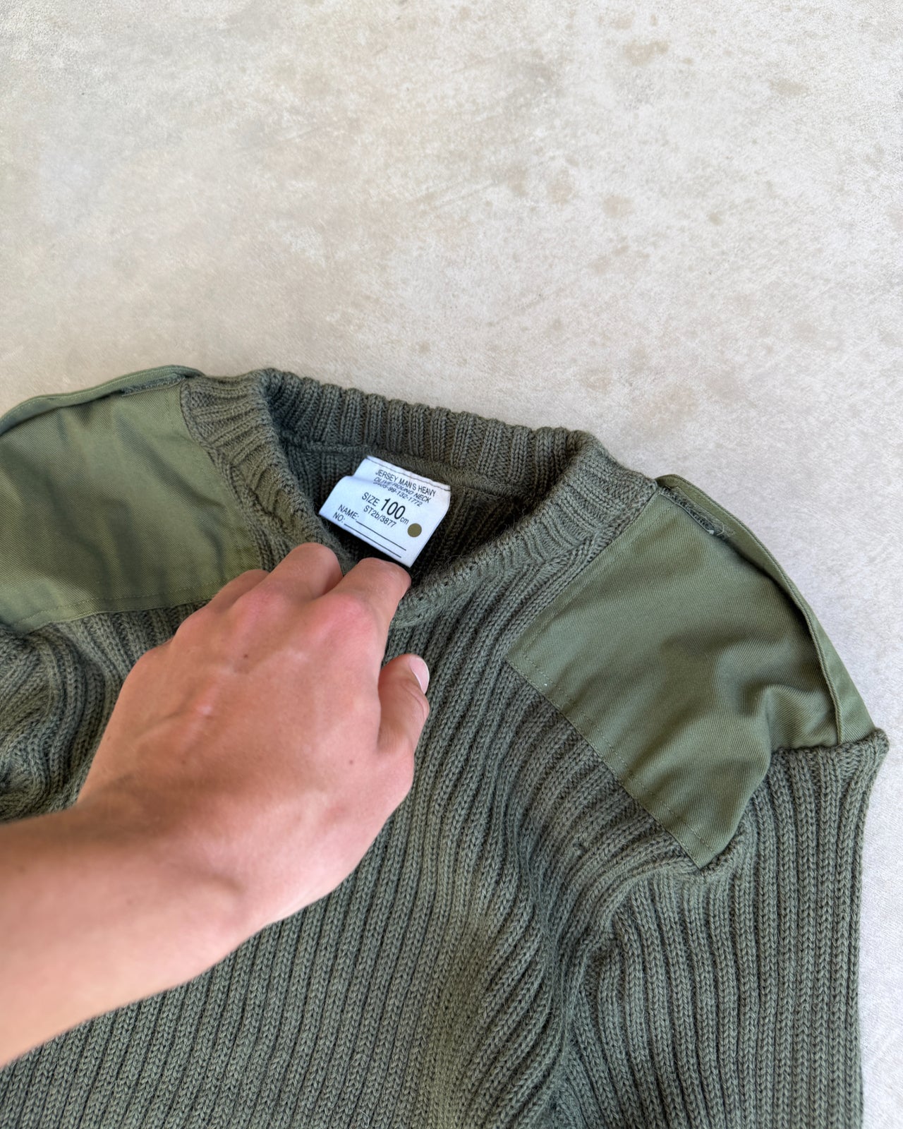 RAF Military Green Knit Sweatshirt – M-on a concrete background