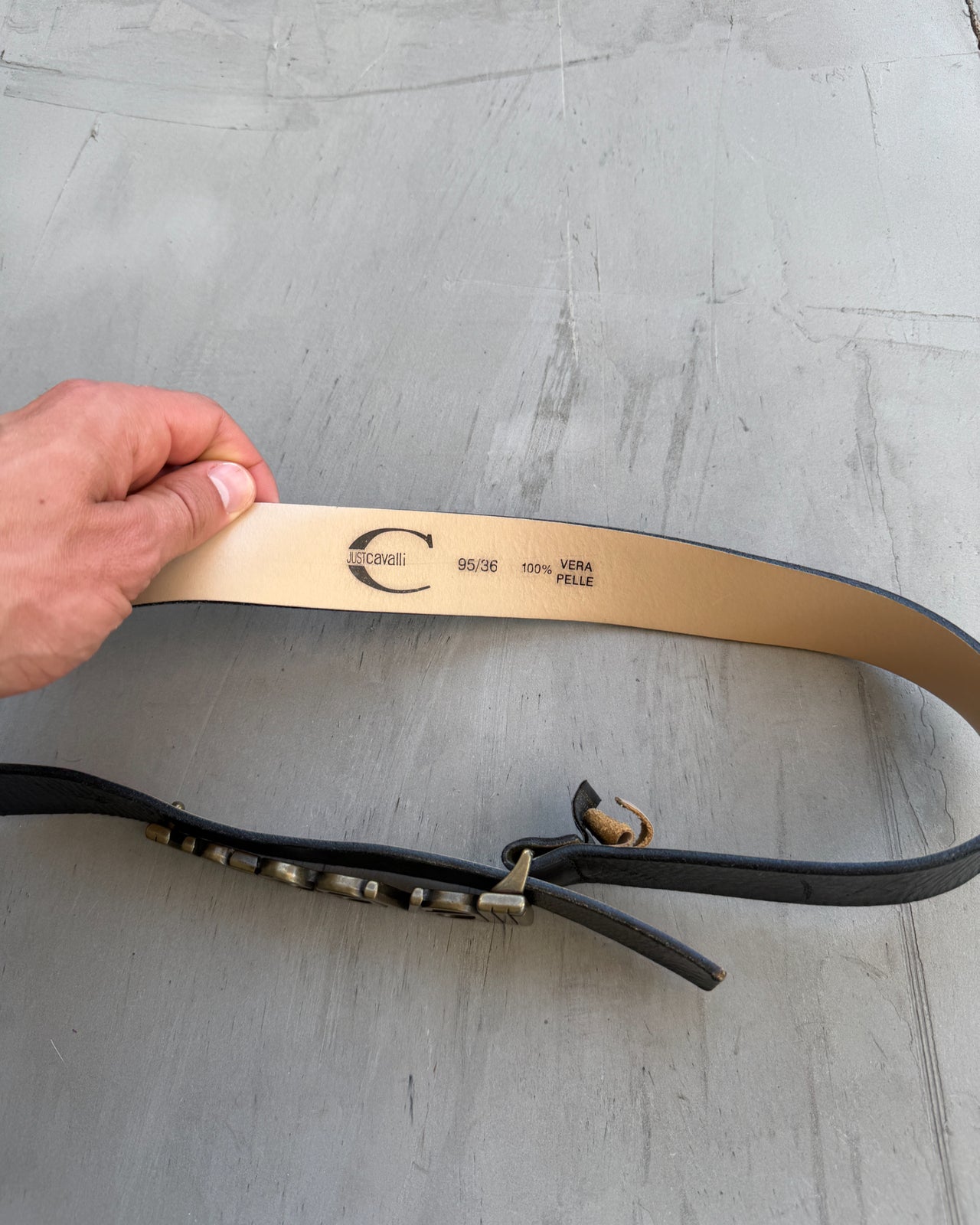 Just Cavalli Black Leather Belt-on a concrete background