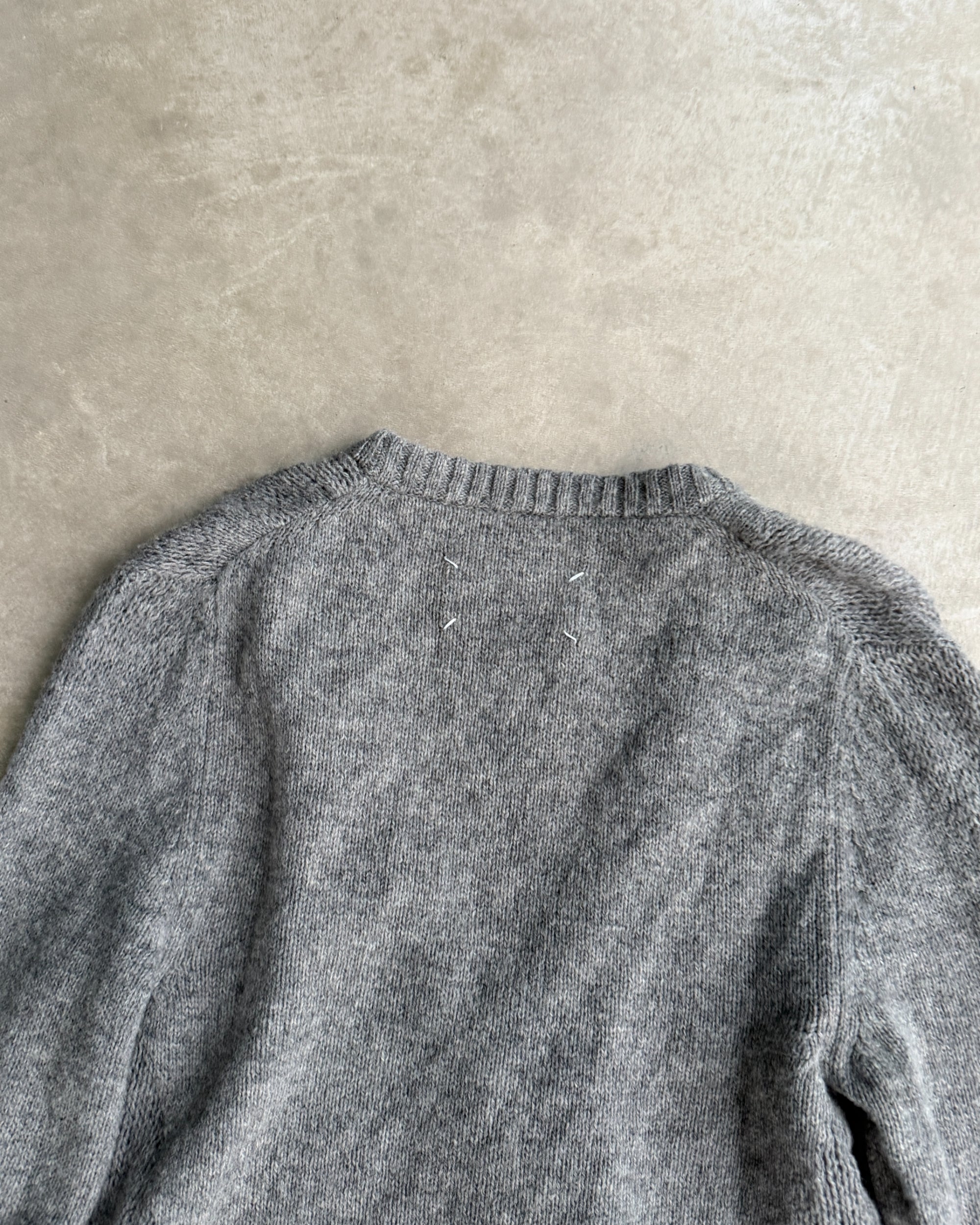 Maison Margiela 10 Wool Cardigan – S-on a concrete background
