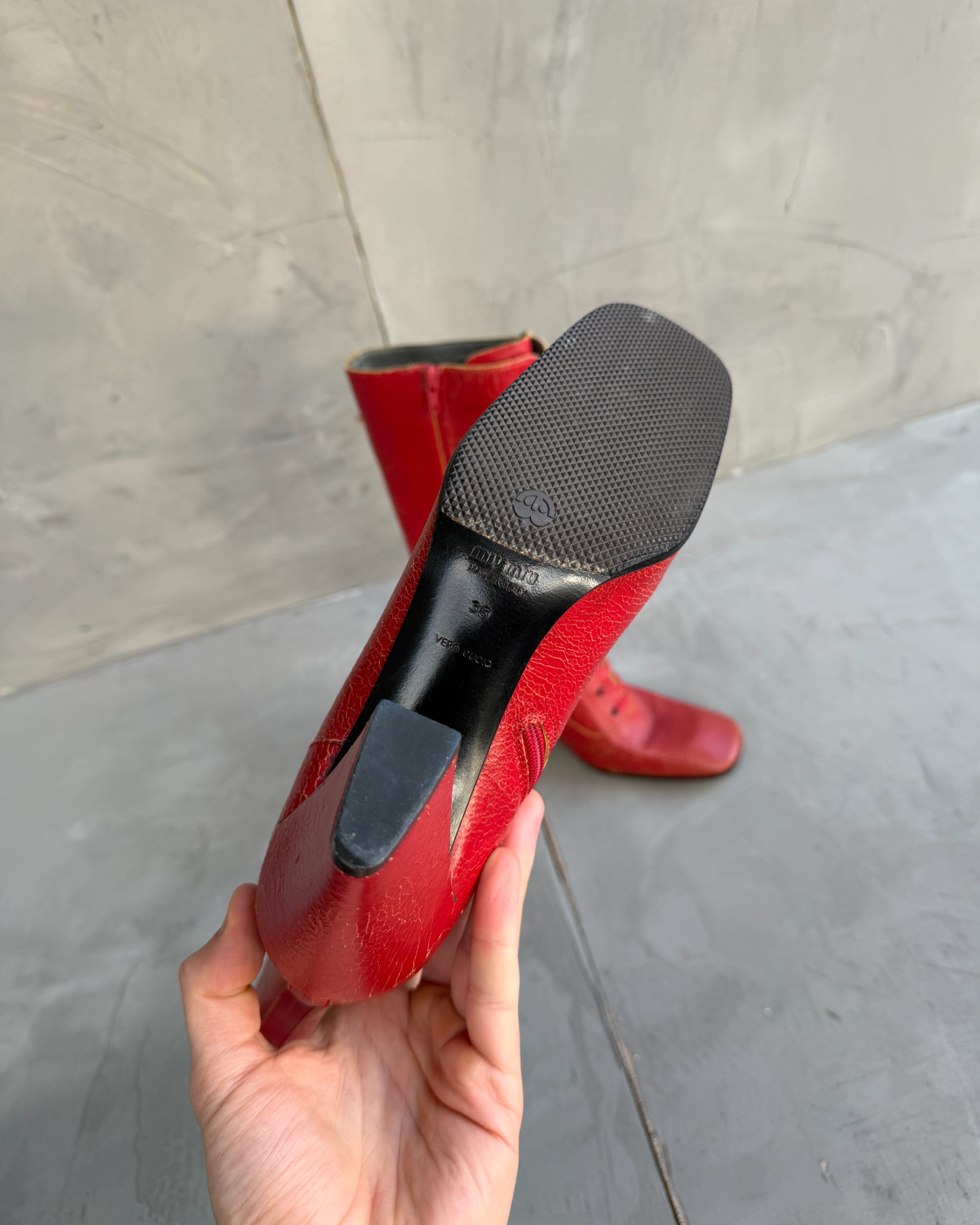 Miu Miu FW01 Cracked Leather Red Lace-Up Boots – EU 38-on a concrete background