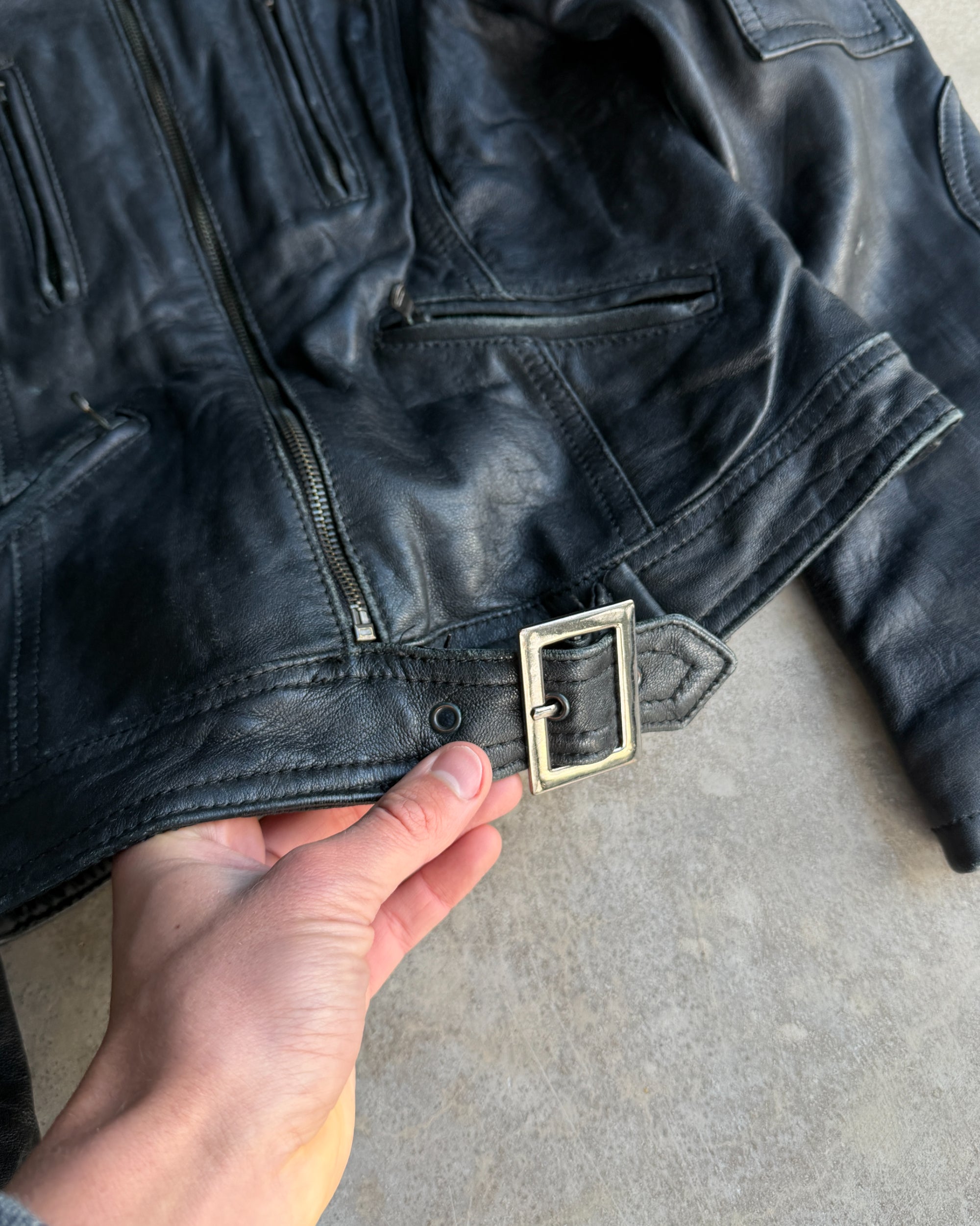 Italian Black Leather Multi-Pocket Jacket – S-on a concrete background