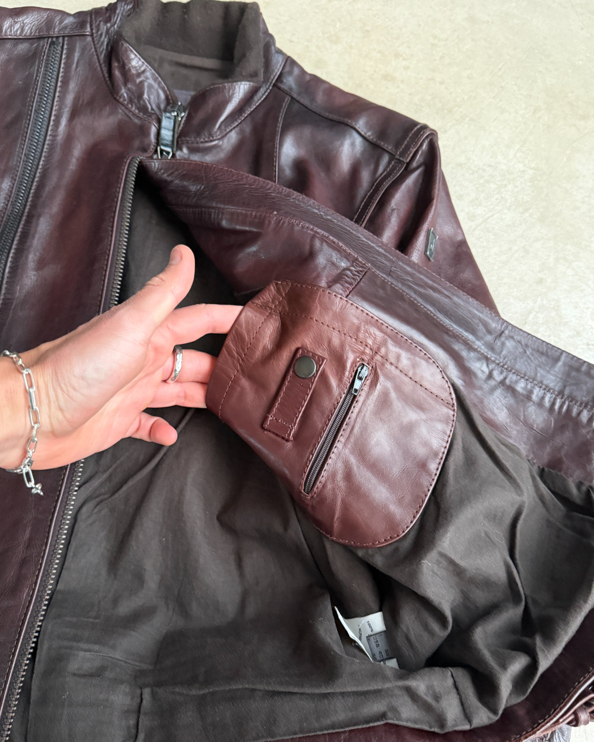 Calvin Klein Buckle Leather Jacket – M-on a concrete background