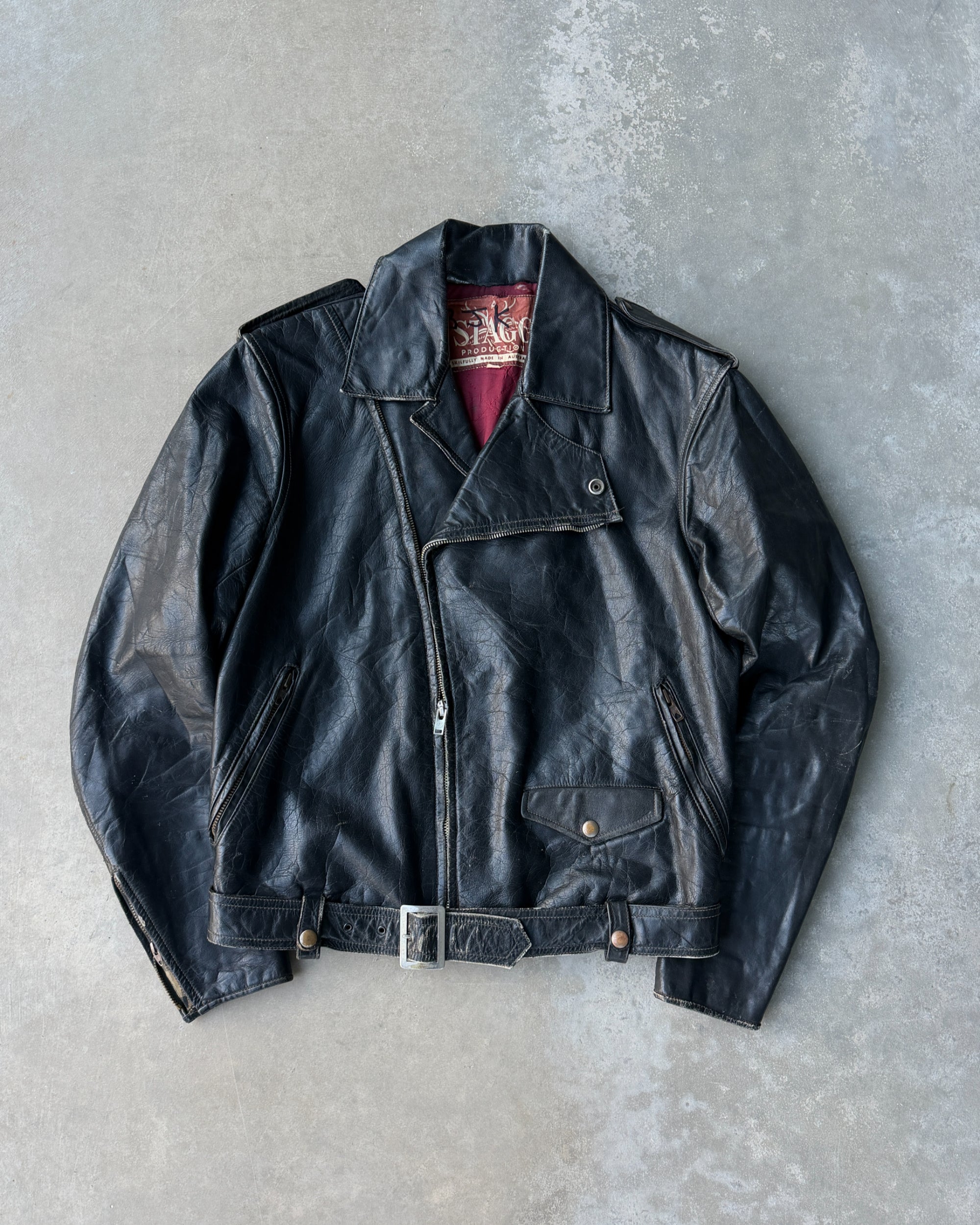 1960s Staggs Leather Moto Jacket – S-on a concrete background