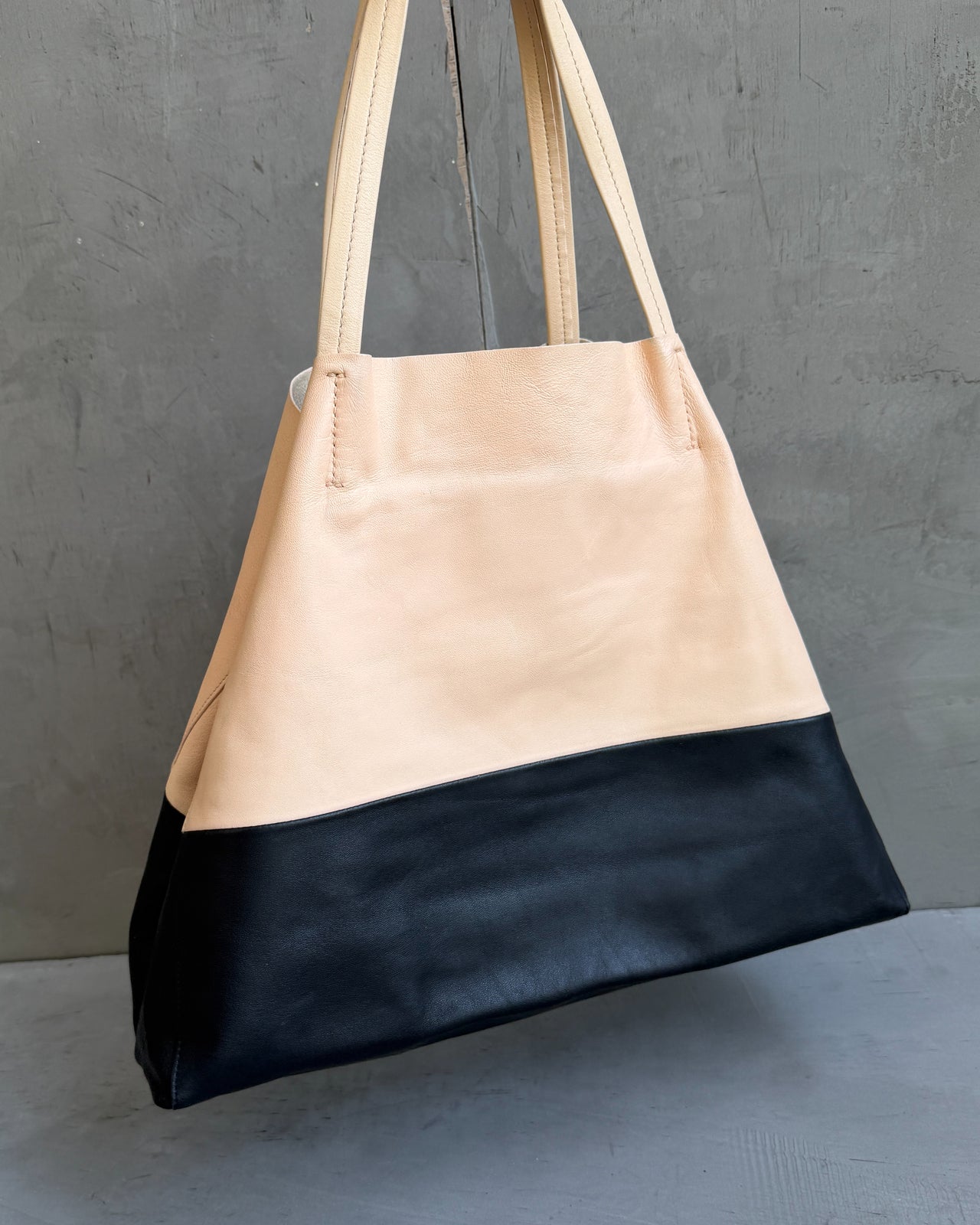 Celine Two Tone Leather Tote Bag-on a concrete background
