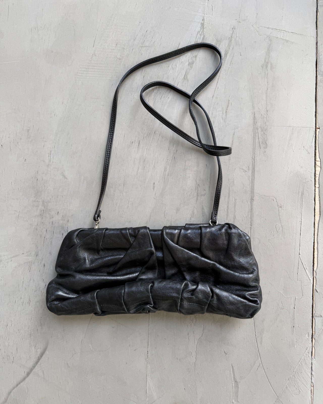 Giorgio Armani Pleated Leather Clutch Bag-on a concrete background