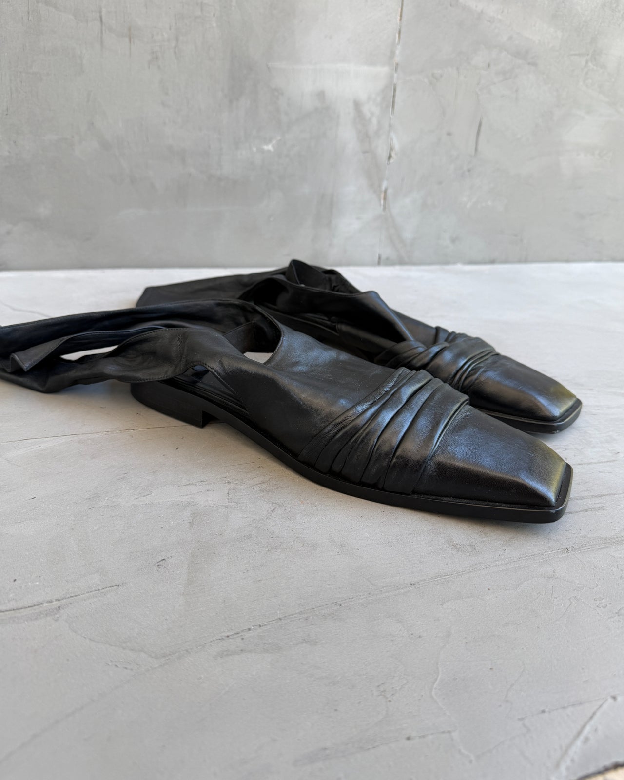 Nina Ricci Black Leather Square Toe Mule – EU 40-on a concrete background