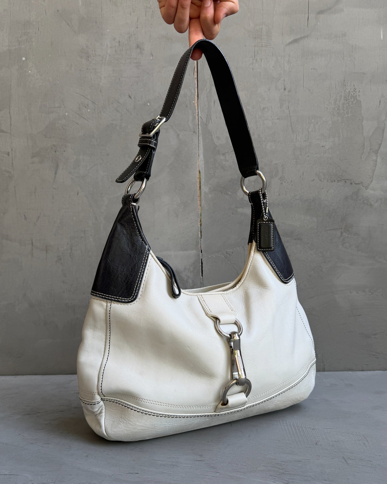 Coach Two Tone Leather Shoulder Bag-on a concrete background