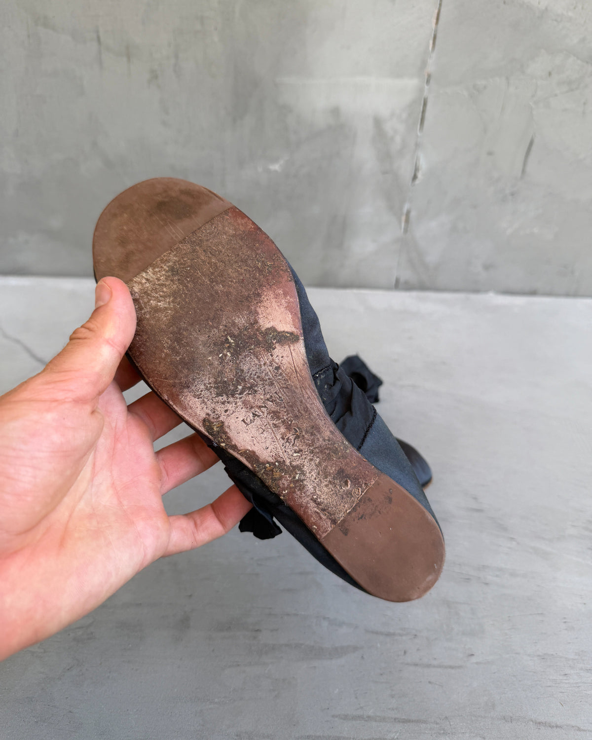 Lanvin Silk Ballet Flat with Ankle Tie-on a concrete background
