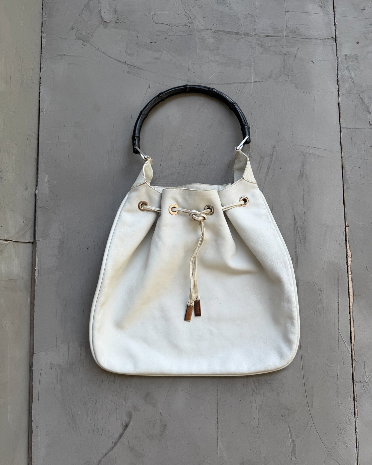 Gucci by Tom Ford White Leather Bag-on a concrete background