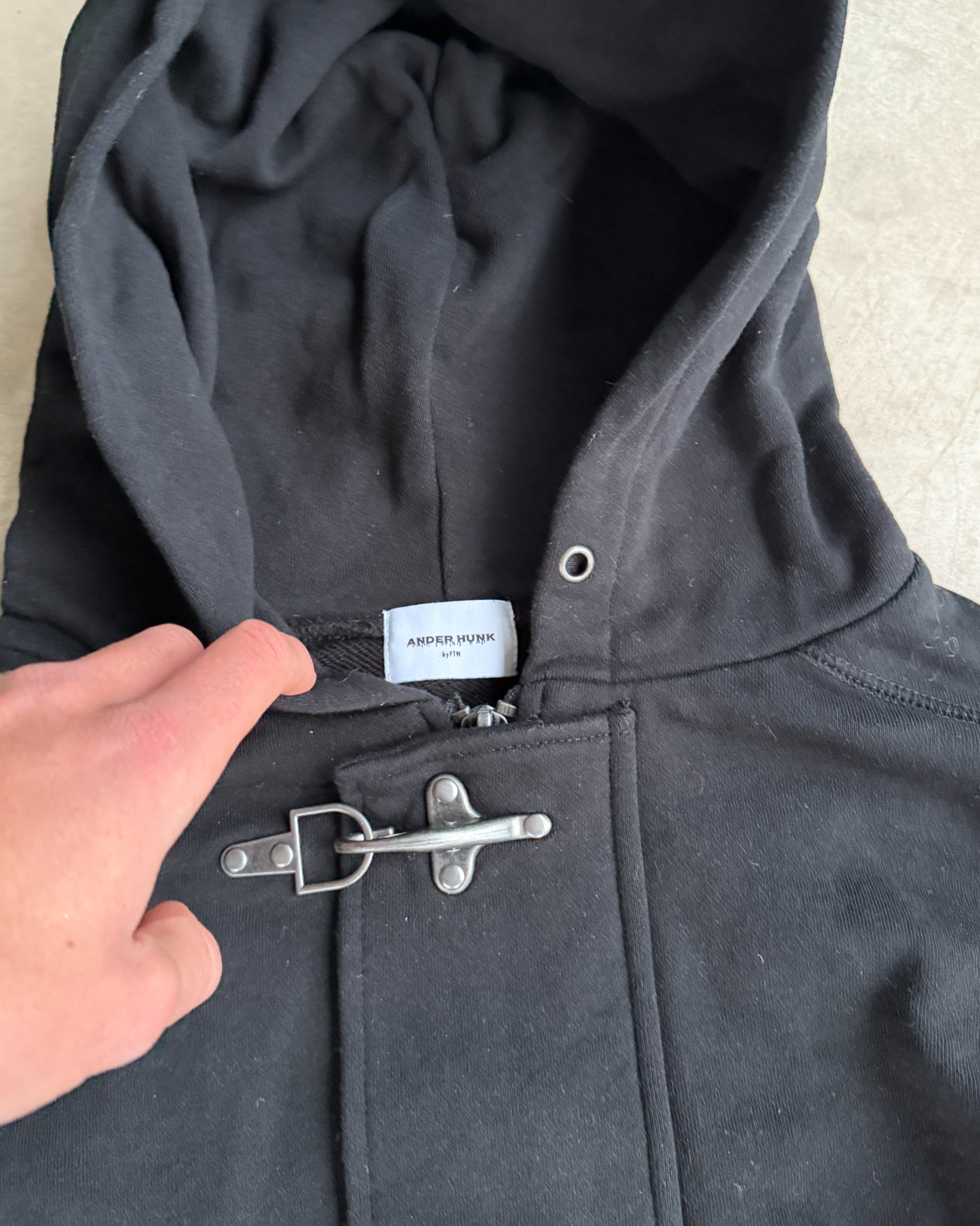 Ander Hunk Fireman Clasp Hoodie – M-on a concrete background