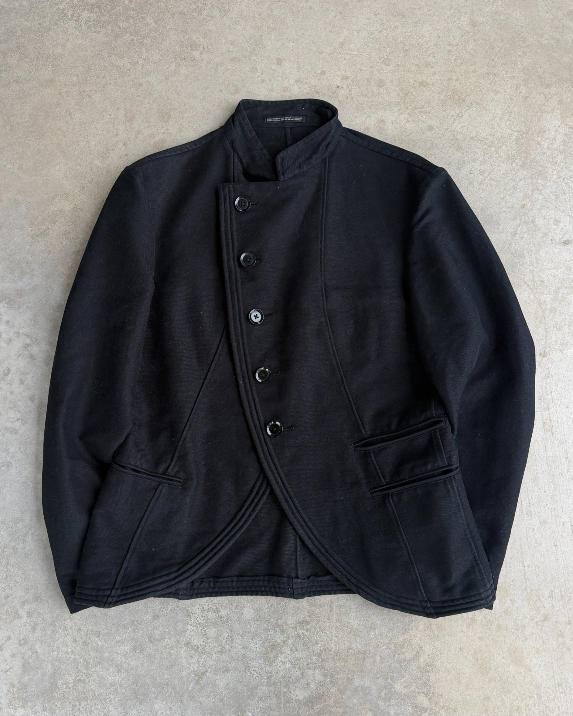 Yohji Yamamoto AW06 Asymmetric Cotton Jacket – S-on a concrete background