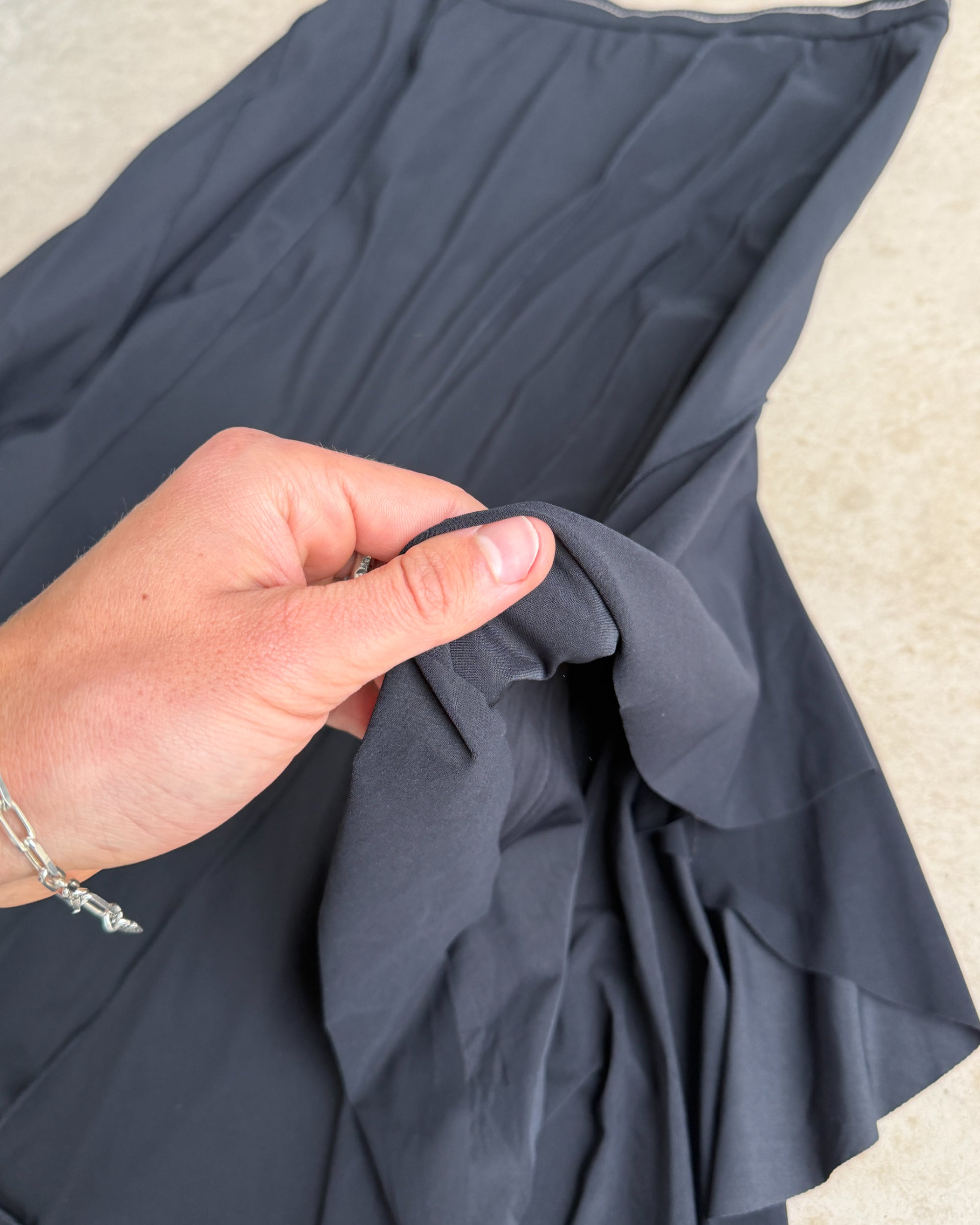 Marithé + François Girbaud Asymmetric Maxi Skirt – S-on a concrete background