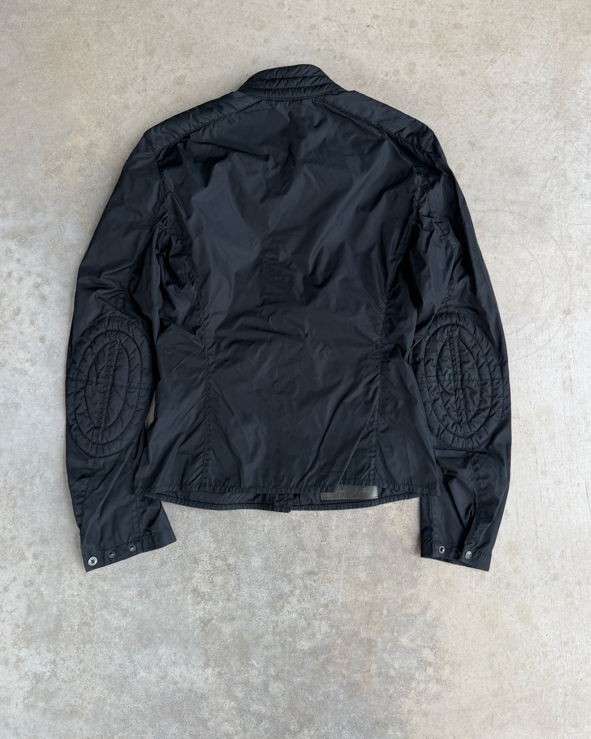 Prada SS99 Nylon Jacket with Elbow Patches – M-on a concrete background