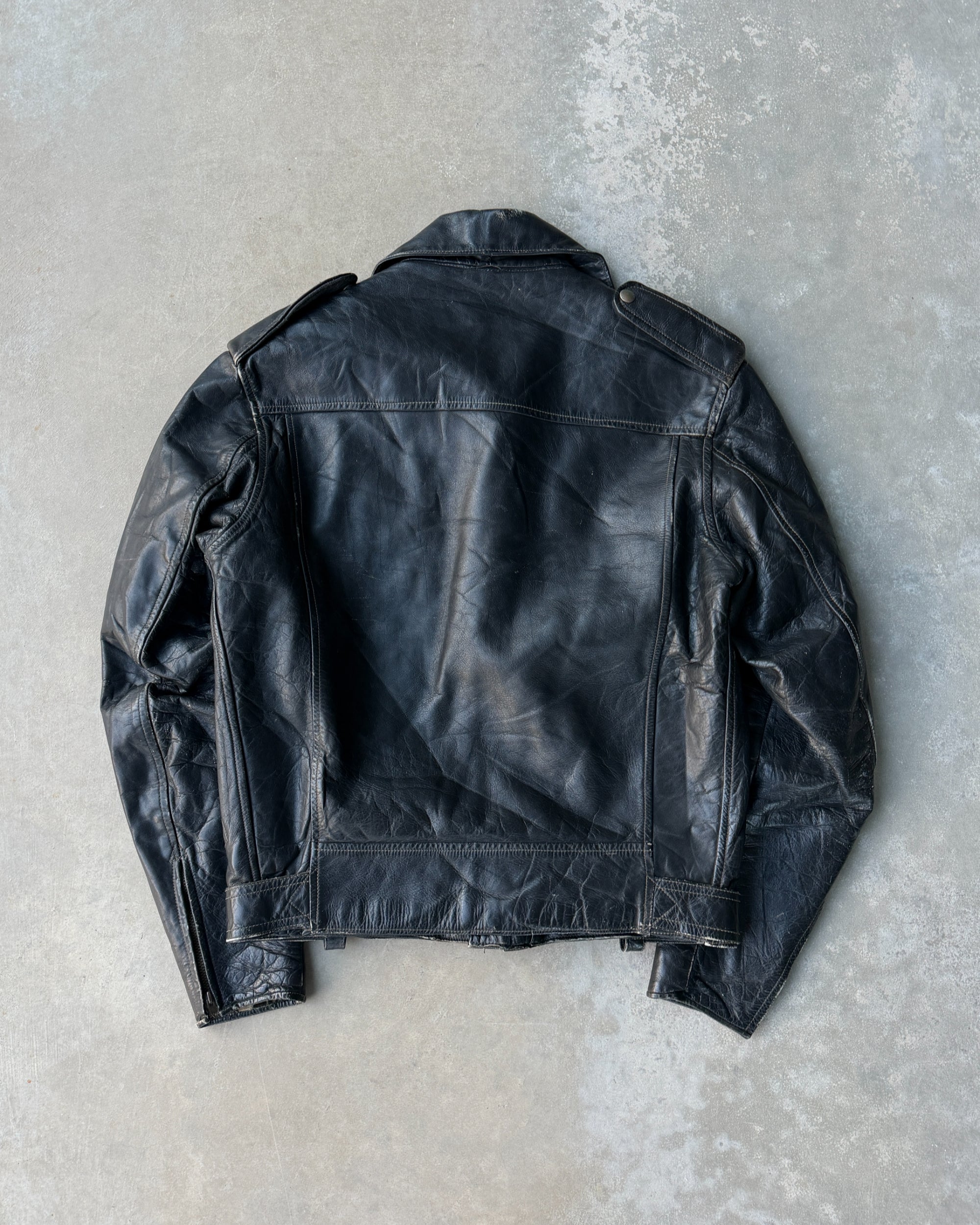 1960s Staggs Leather Moto Jacket – S-on a concrete background