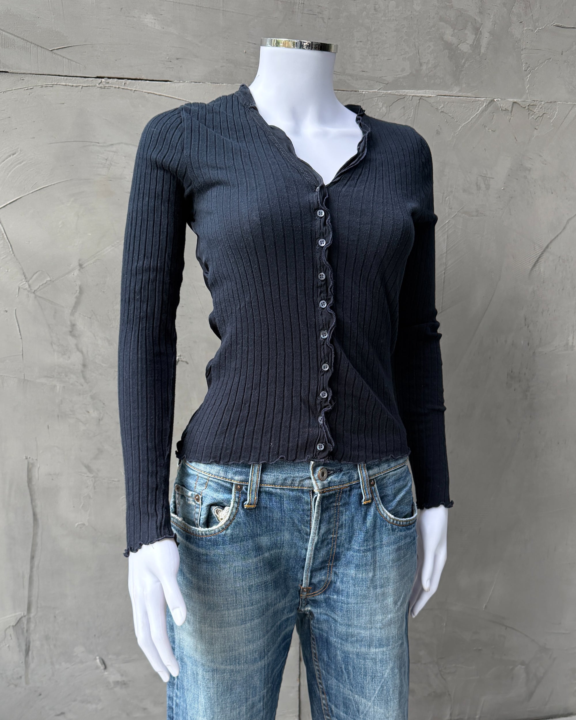 Marithé + François Girbaud MFG Button-Up Top – S-on a concrete background