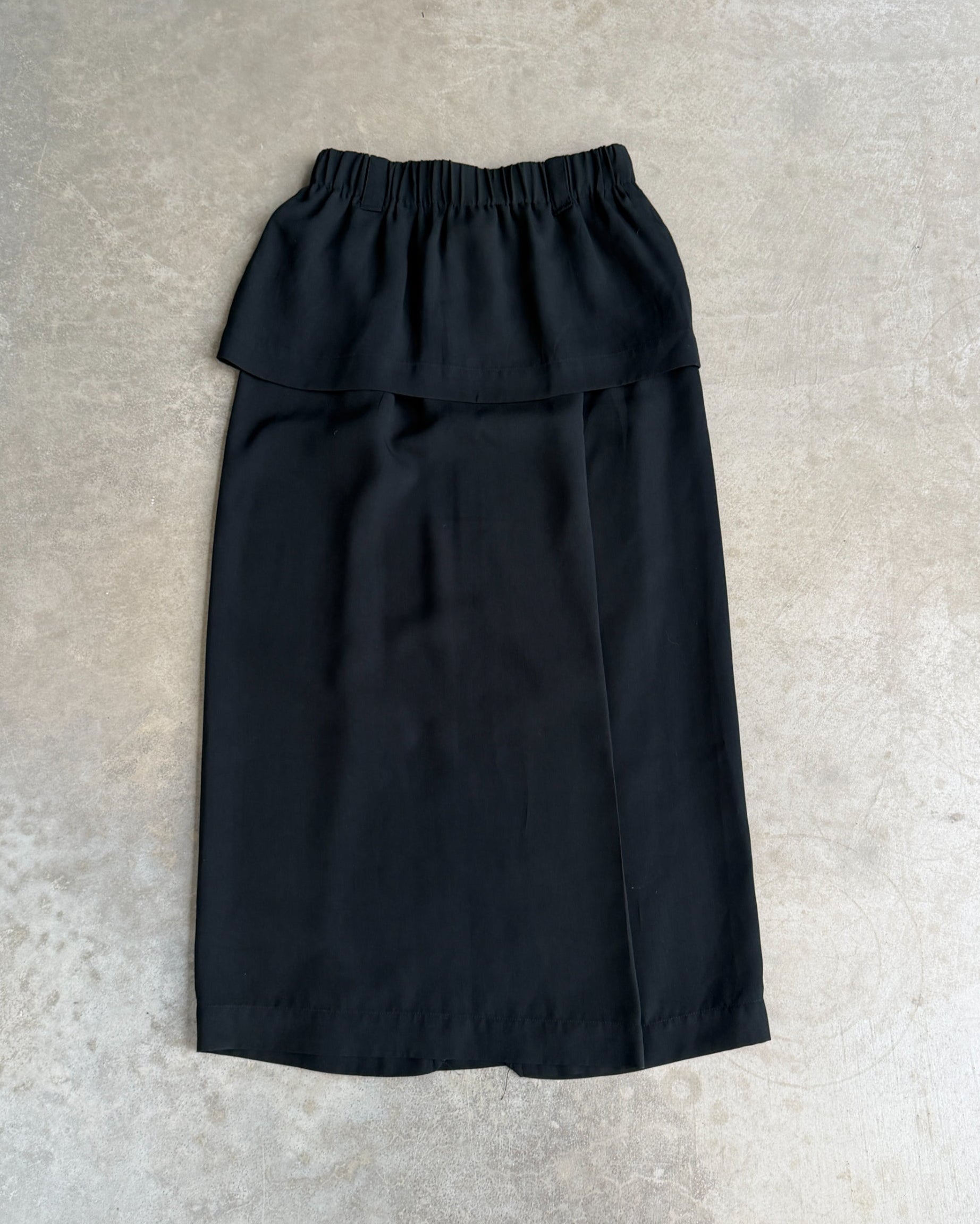 Issey Miyake Permanente Maxi Skirt – S-on a concrete background
