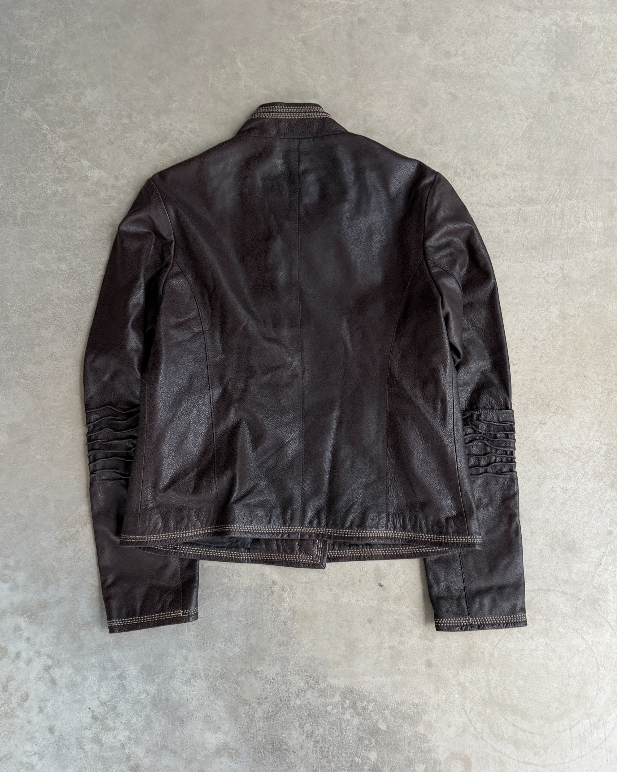 Fahmi Asymmetric Button-Up Leather Jacket – M-on a concrete background