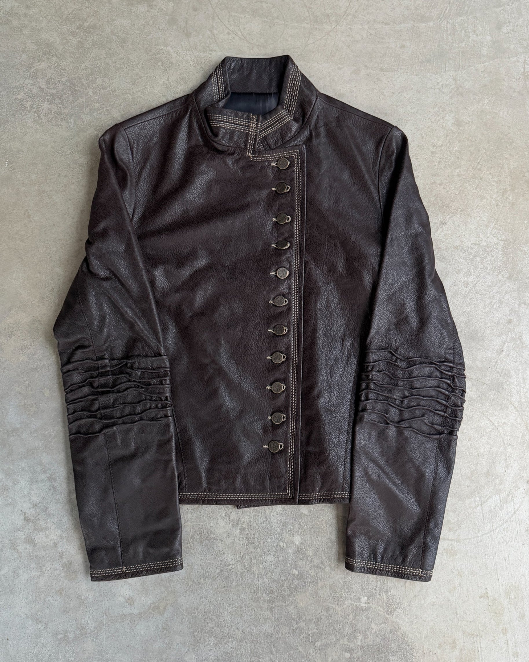 Fahmi Asymmetric Button-Up Leather Jacket – M-on a concrete background