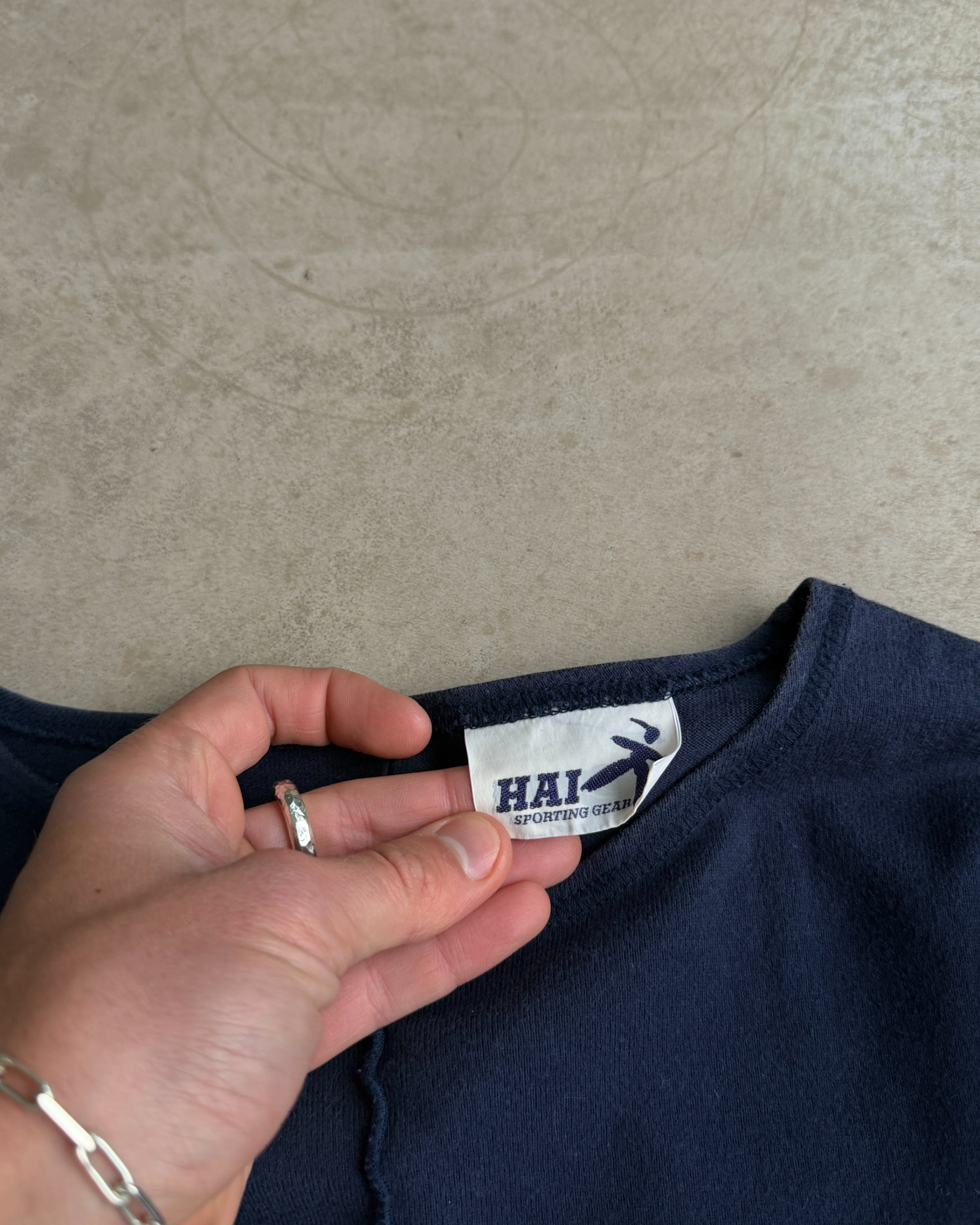Hai Sporting Gear Blue Top – S-on a concrete background