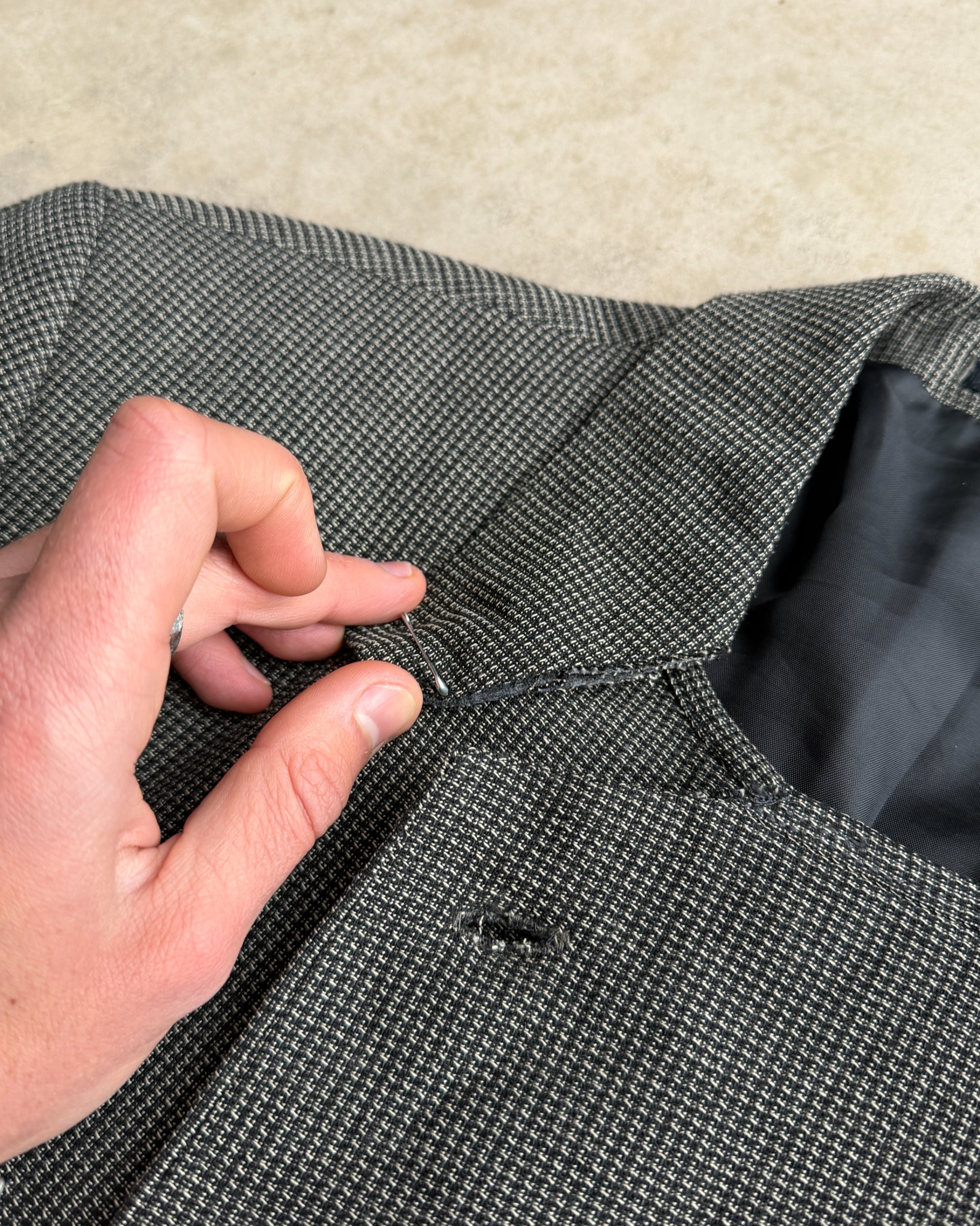 M Classic Altered Wool Jacket with Safety Pins – L-on a concrete background