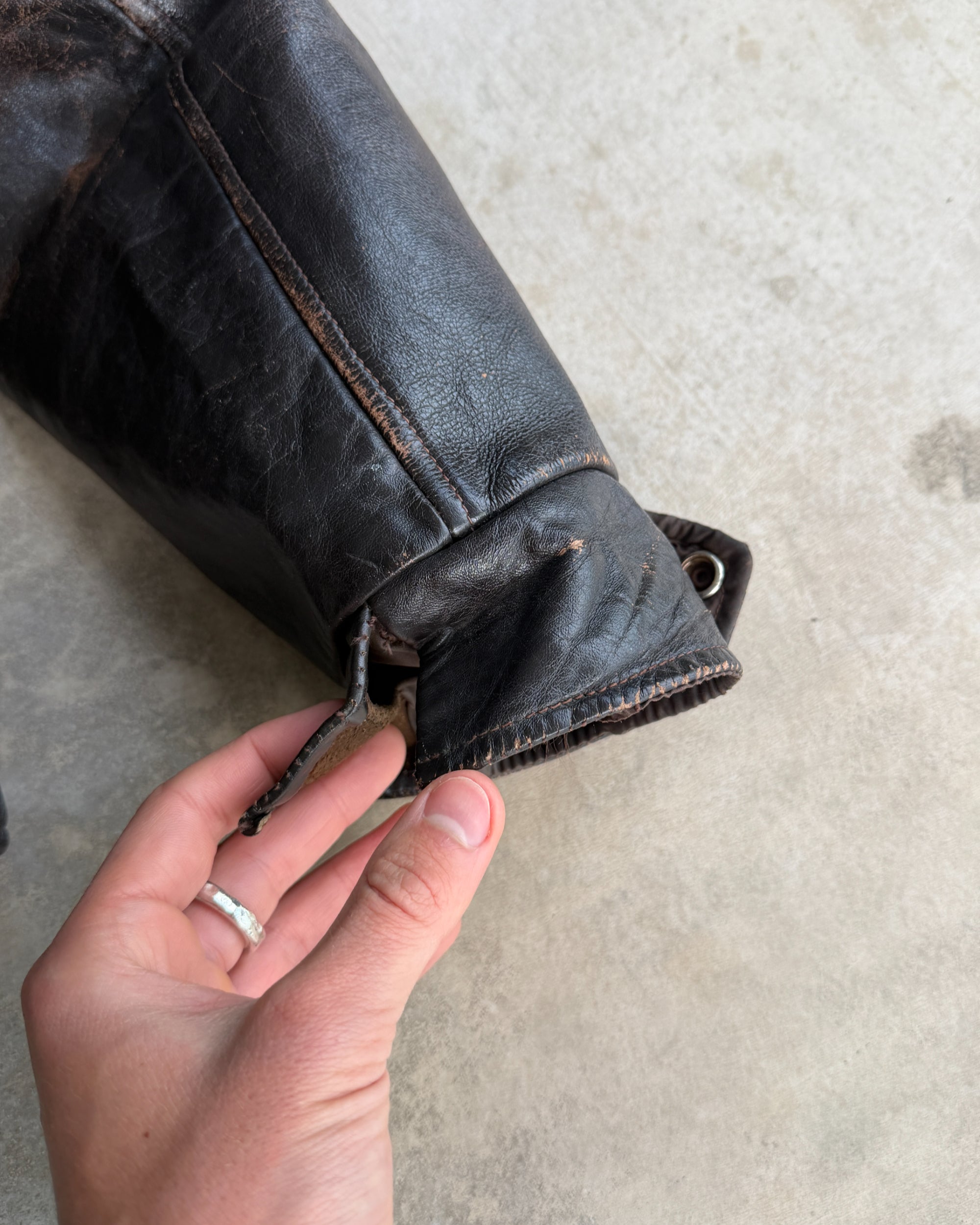 1970s Vintage Leather Jacket with Wool Lining – S-on a concrete background