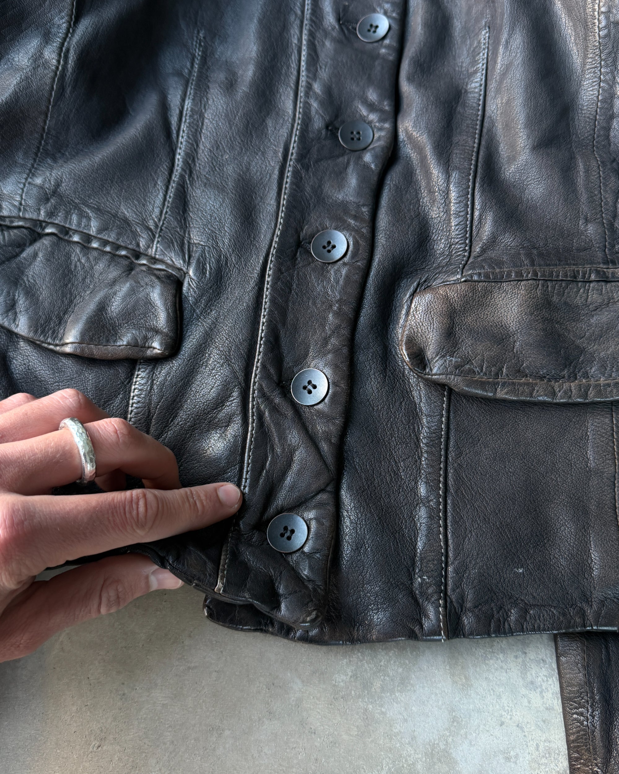 AllSaints 1990s Button-Up Leather Jacket – M-on a concrete background