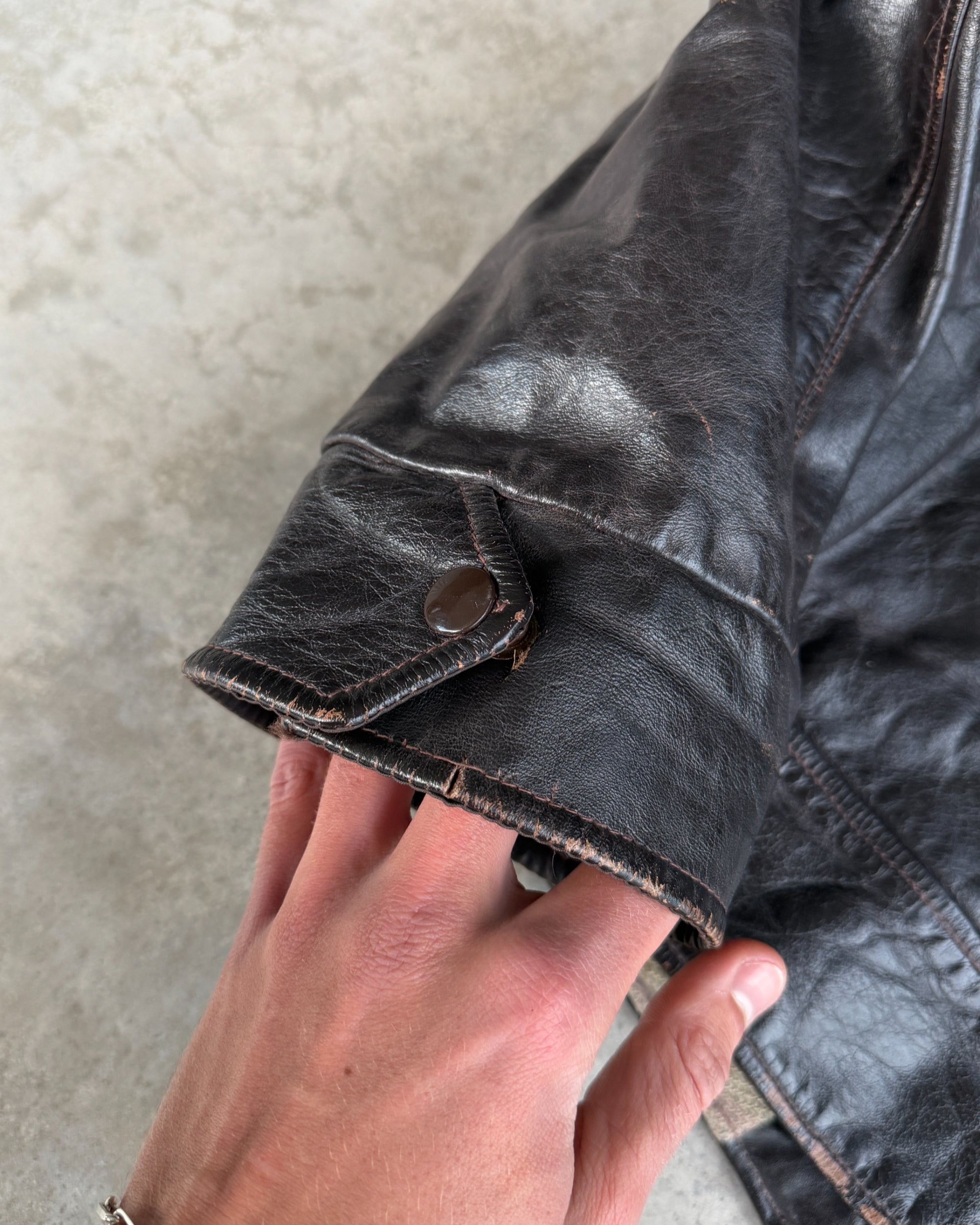 1970s Vintage Leather Jacket with Wool Lining – S-on a concrete background