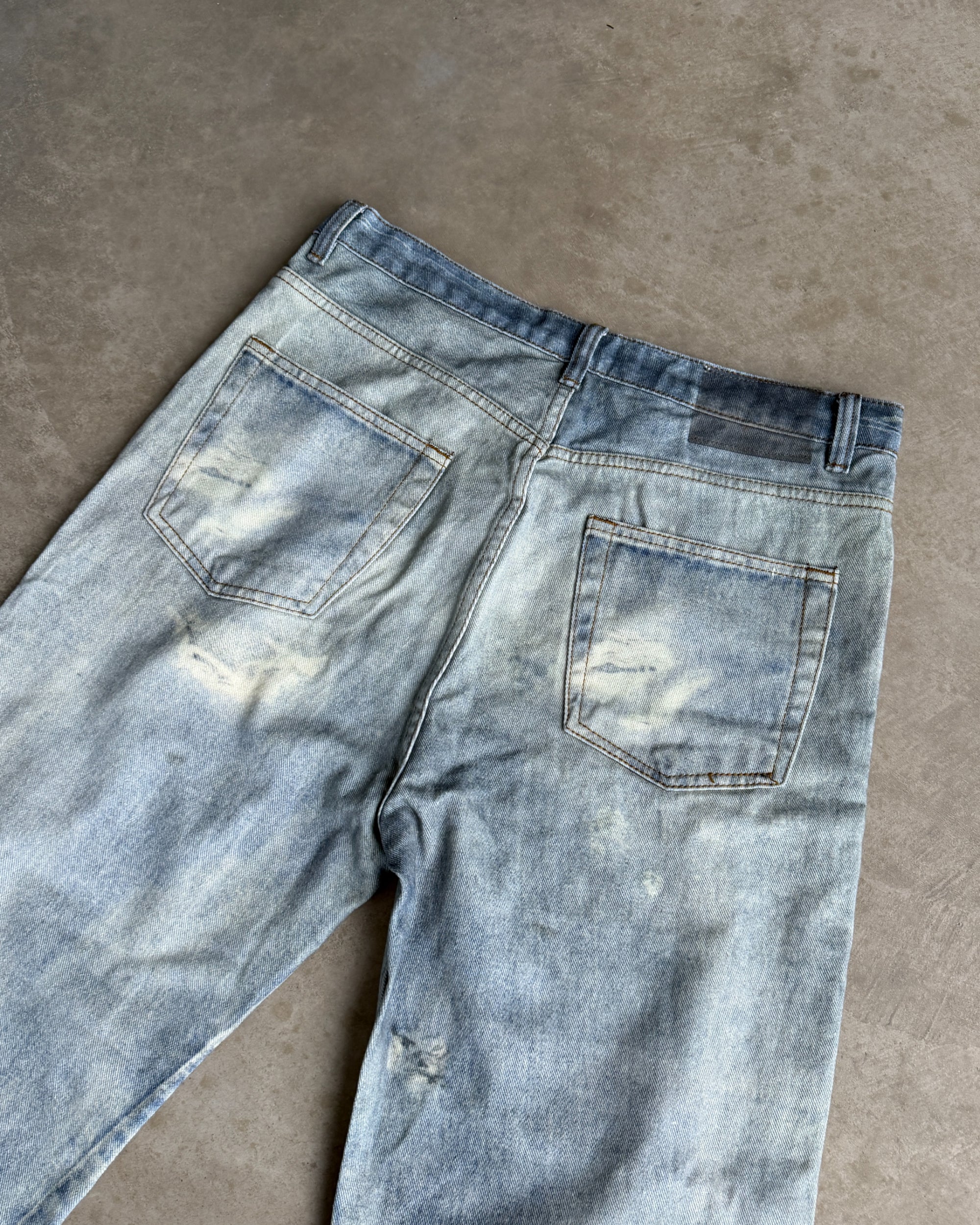 Our Legacy Third Cut Digital Print Distressed Denim Jeans – W30–32-on a concrete background