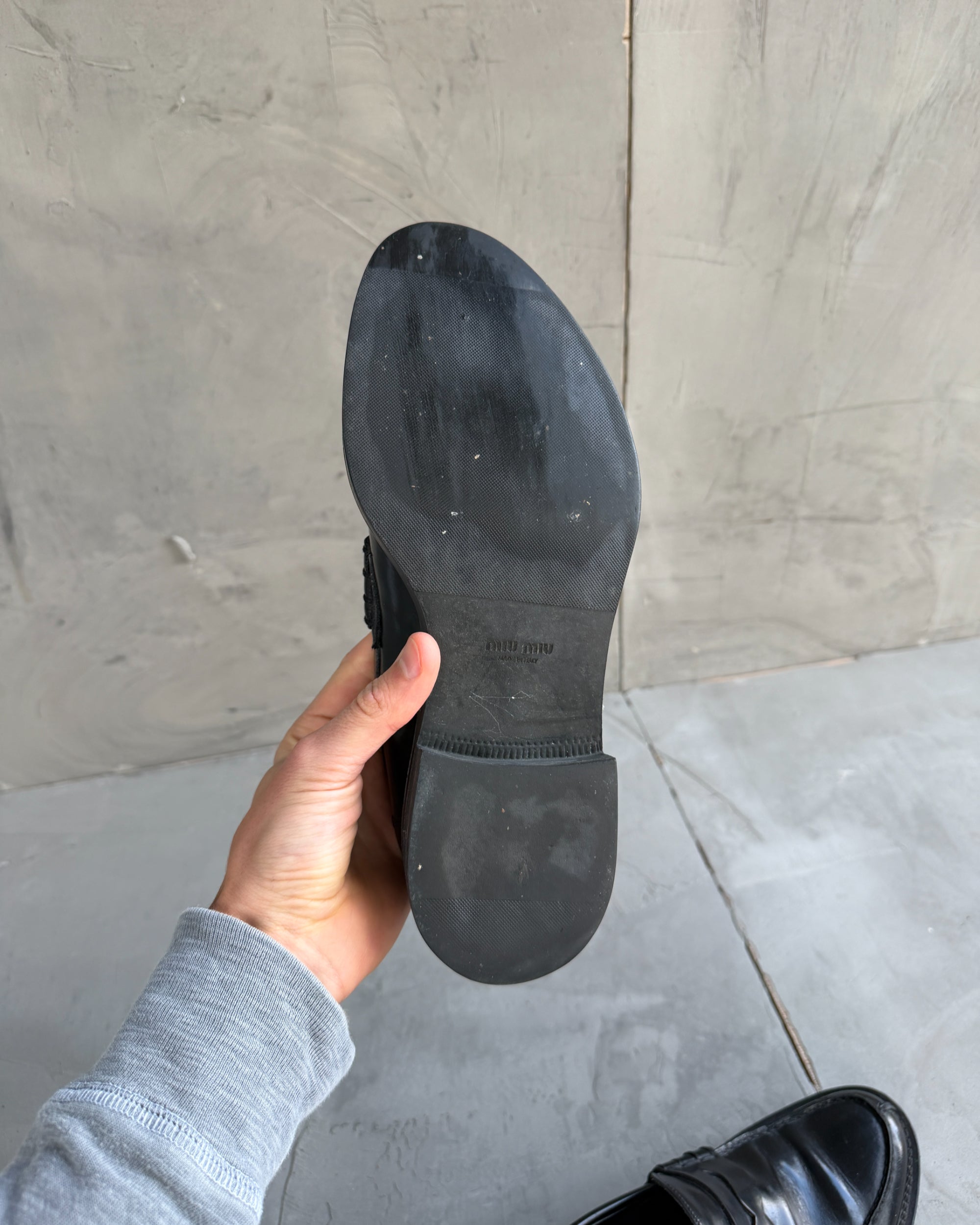 Miu Miu Black Leather Loafers – EU 40-on a concrete background