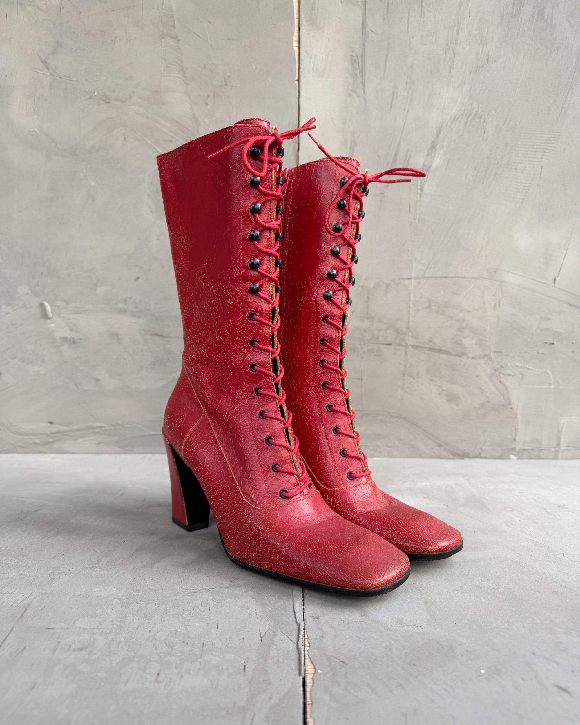 Miu Miu FW01 Cracked Leather Red Lace-Up Boots – EU 38-on a concrete background